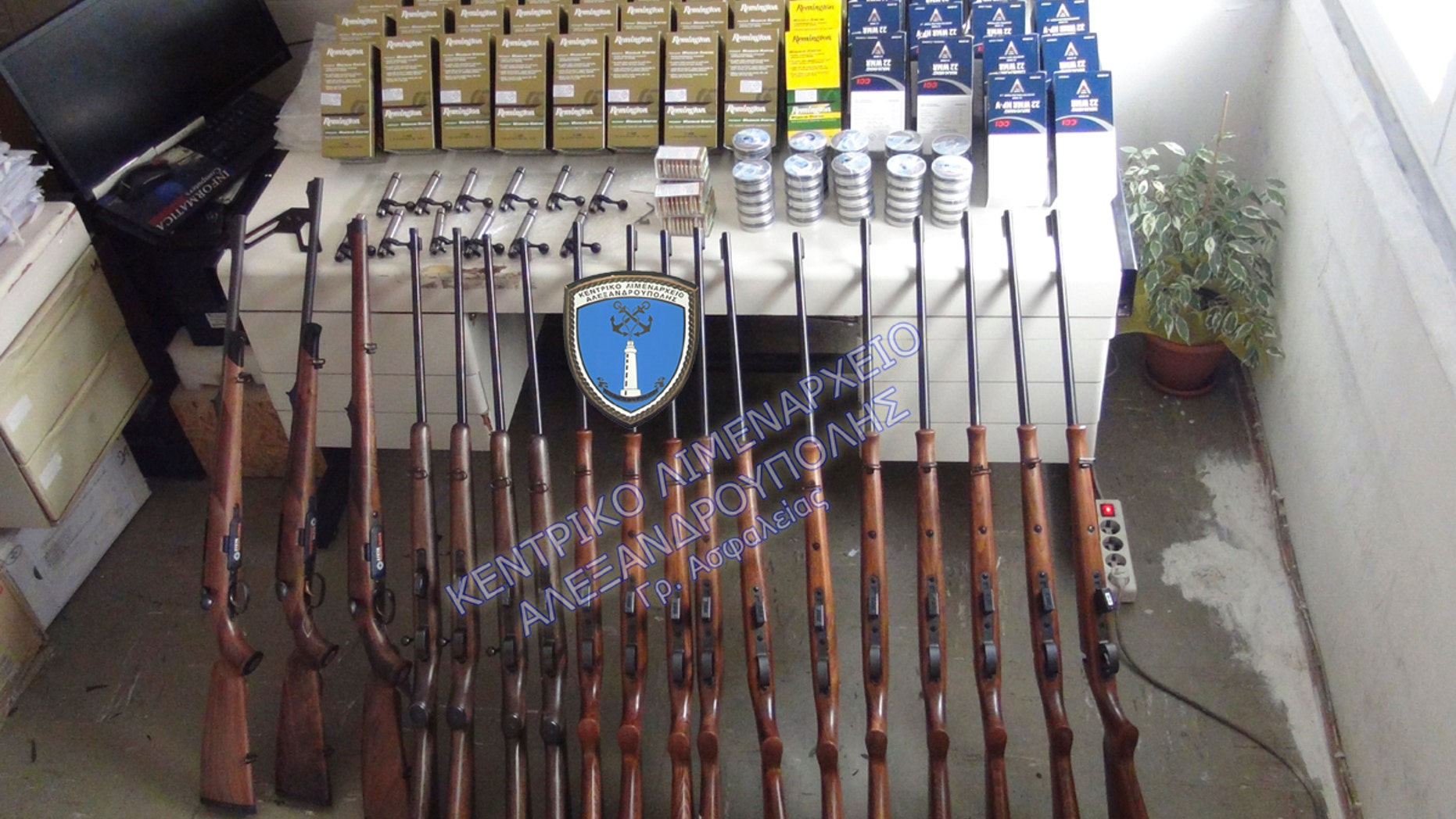 This undated photo shows rifles and bullets confiscated after the arrest of two British citizens in Alexandroupolis. Following this arrest, Greek police say they arrested another man carrying four air rifles, eight scopes and 200,000 bullets.