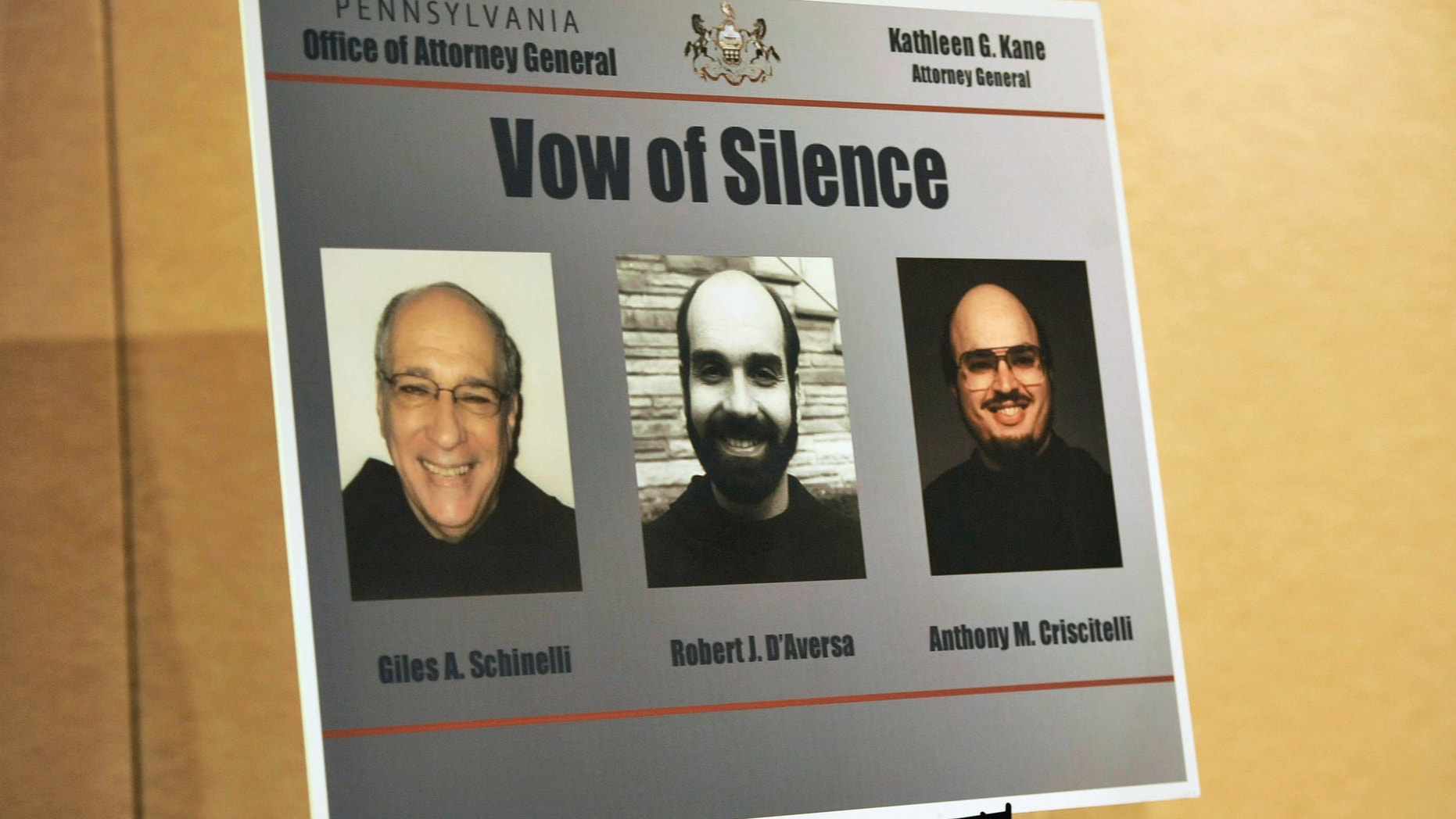 A poster from the Pennsylvania State Attorney General with the images of three ex-leaders of the Franciscan religious order.