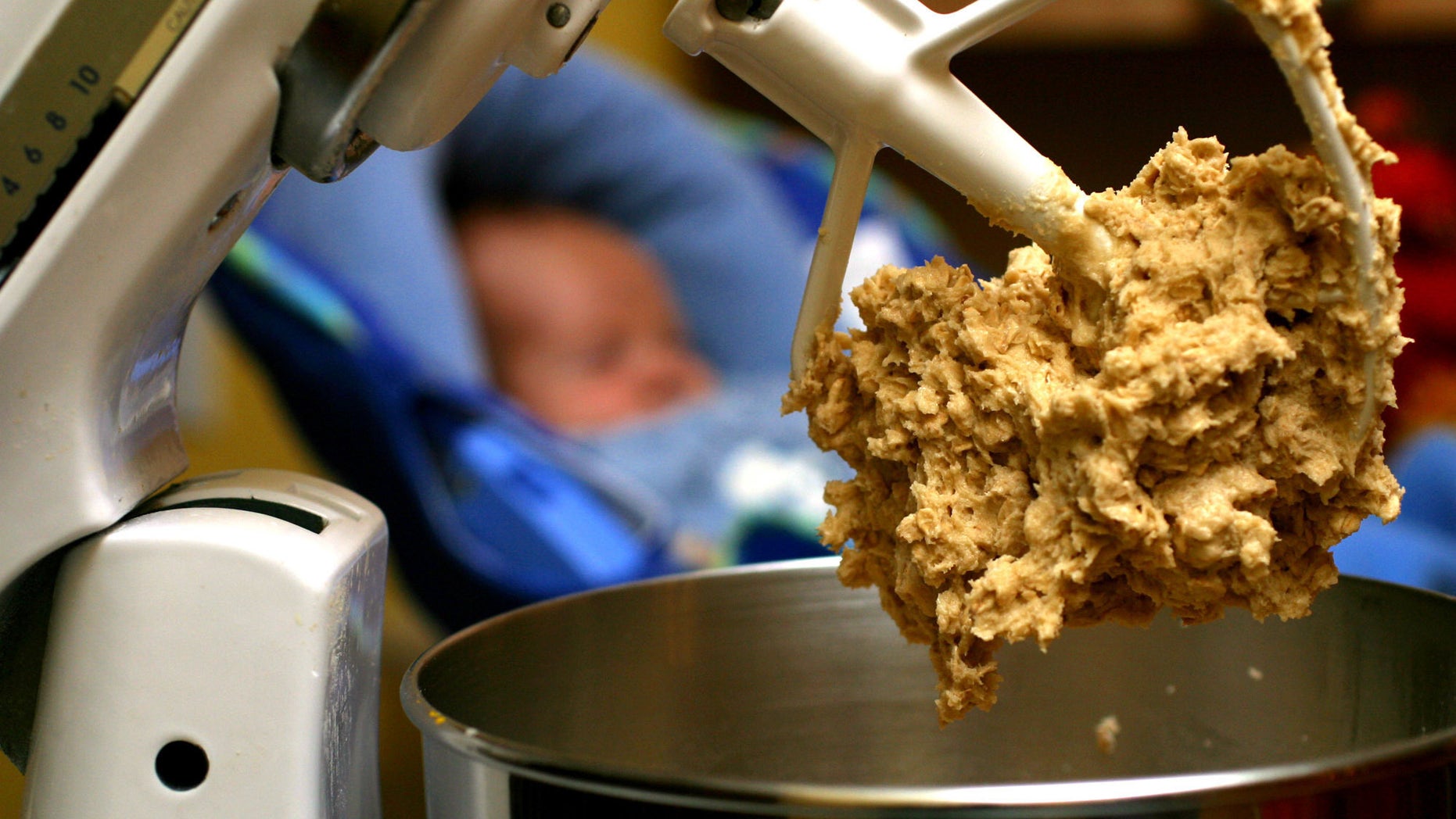 In this undated file photo, cookie dough clings to the beaters of a standing mixer.