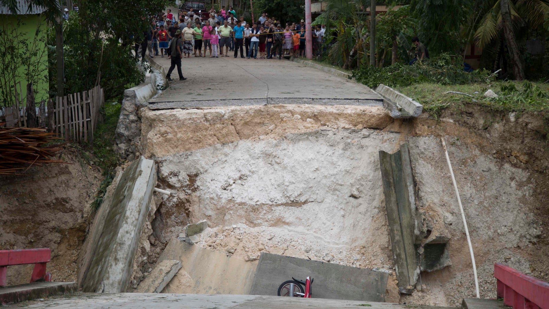 A motorcycle lies in the debris of a collapsed bridge brought down by Hurricane Earl in the Arroyito neighborhood, in Melchor de Mencos, Guatemala on August 4.