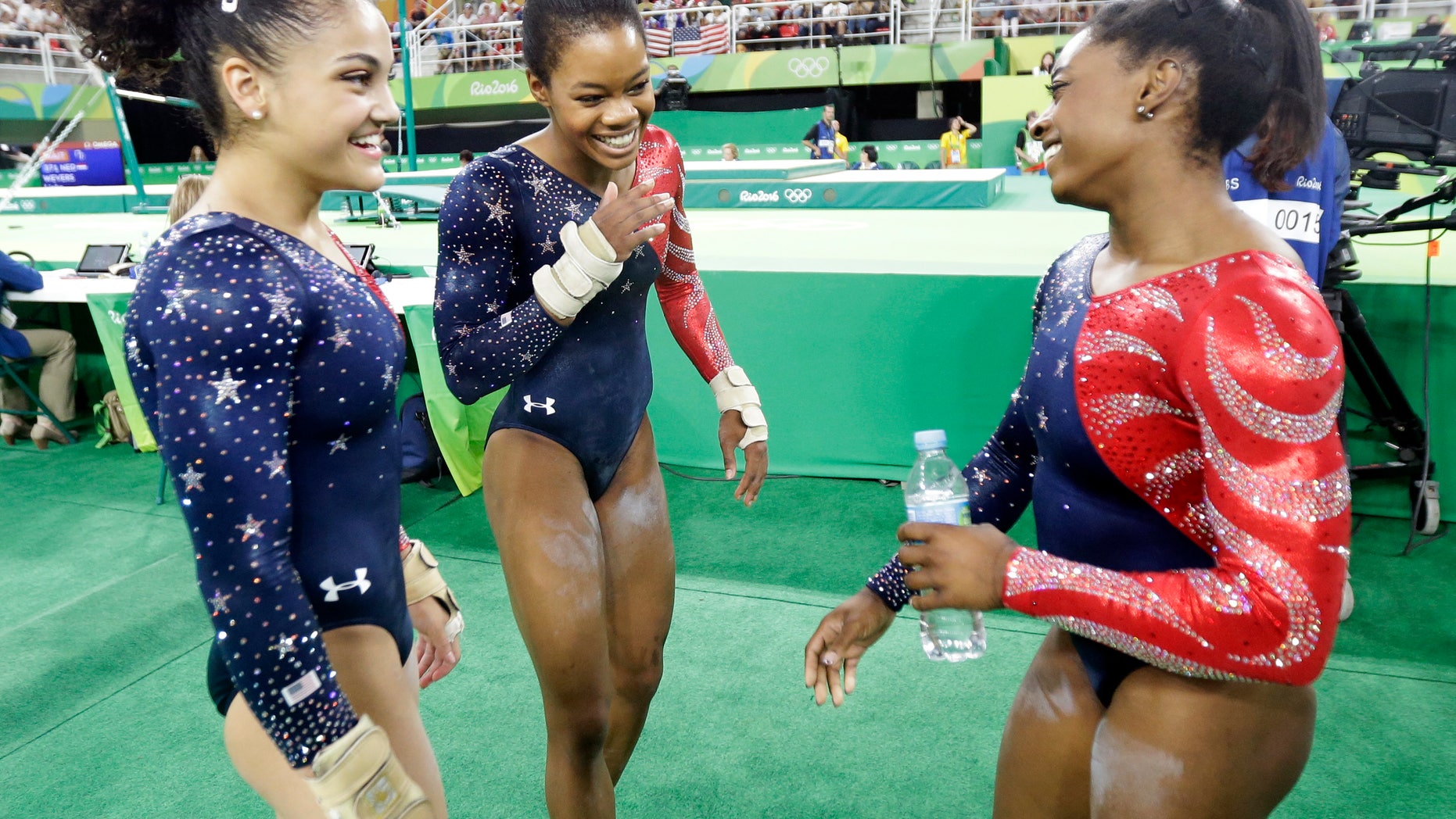 From left, United States' Lauren Hernandez, Gabrielle Douglas and Simone Biles after their floor routine during the artistic gymnastics women's qualification at the 2016 Summer Olympics in Rio de Janeiro, Brazil, Sunday.