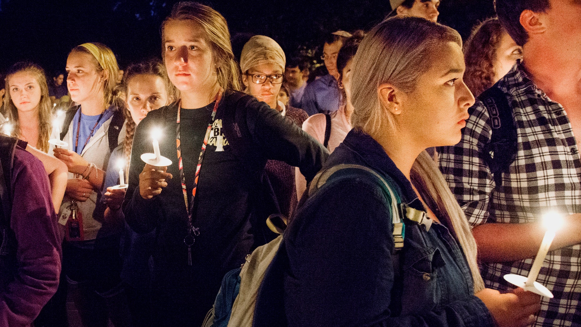 University of Illinois students attend a candlelight vigil in remembrance of the deadly shooting.