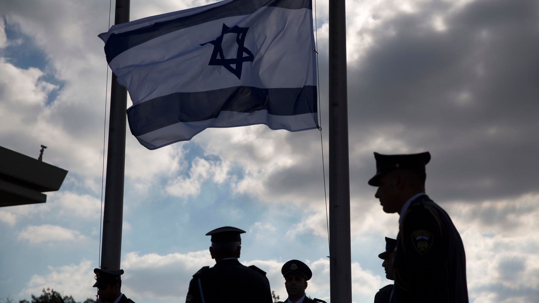 Members of the Knesset guard stand next to the Israeli flag at half-staff in preparations to display the coffin of former Israeli President Shimon Peres at the Knesset, Israel's Parliament, in Jerusalem, Wednesday, Sept. 28, 2016.