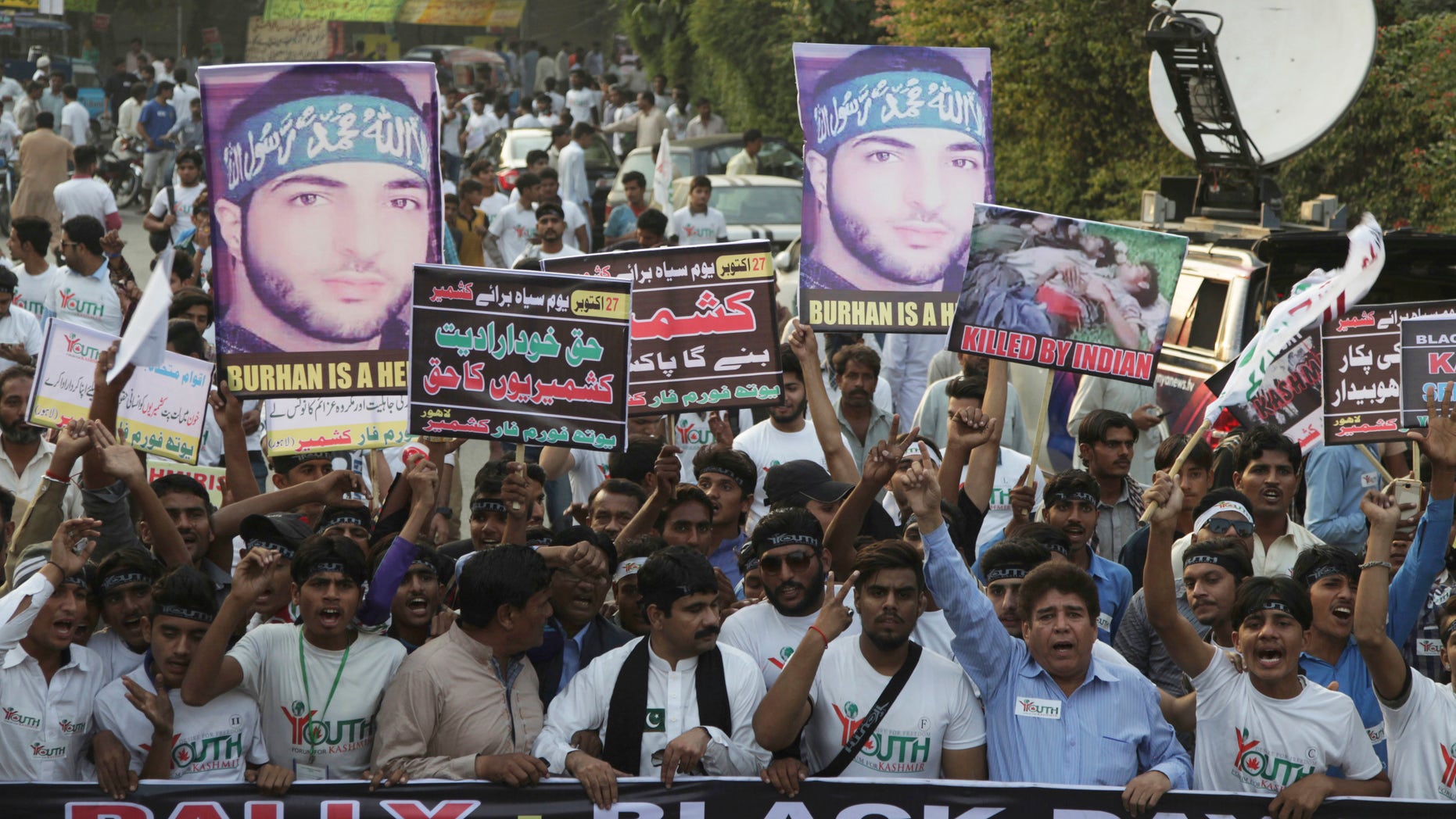 People rally against India to express solidarity with Indian Kashmiris fighting against government forces, in Lahore, Pakistan, Thursday. Pakistan's Foreign Ministry on Thursday said India was expelling a Pakistani diplomat in New Delhi.
