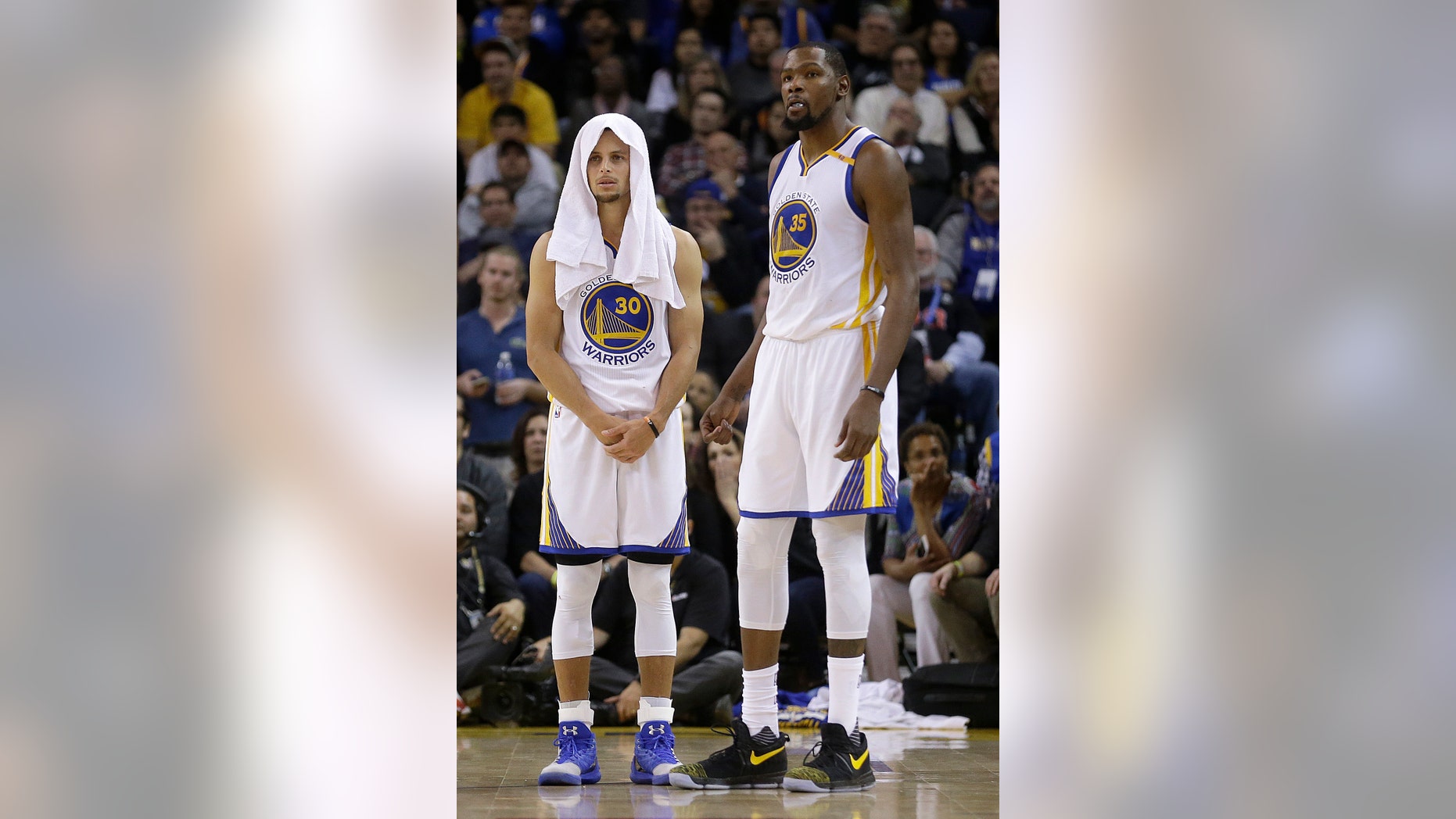 The Golden State Warriors' Stephen Curry, left, and Kevin Durant watch during the second half of Thursday's game.