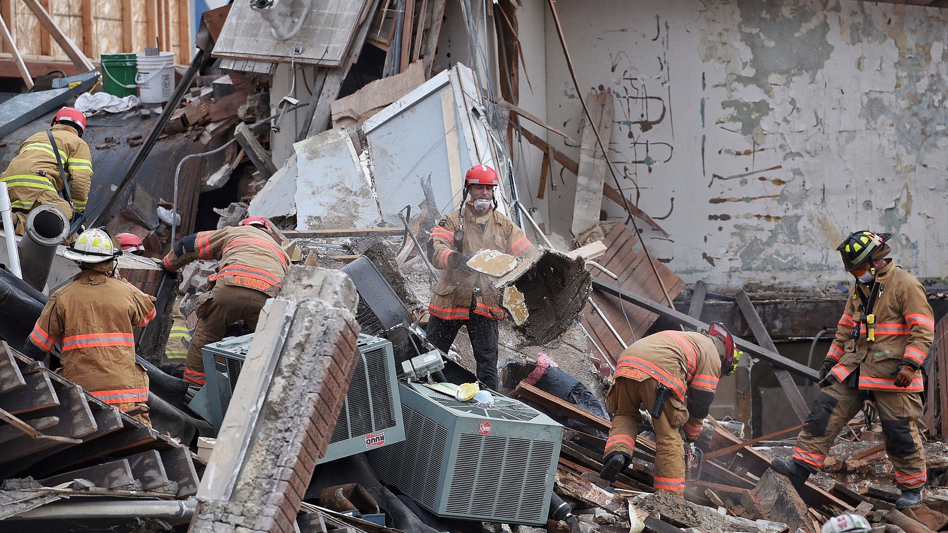 Emergency crews clear debris at the scene of the building collapse in Sioux Falls.