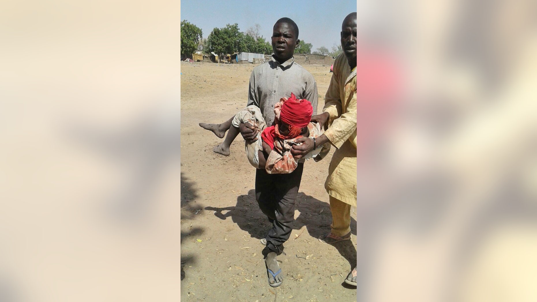 A man carries an injured child after the airstrike.