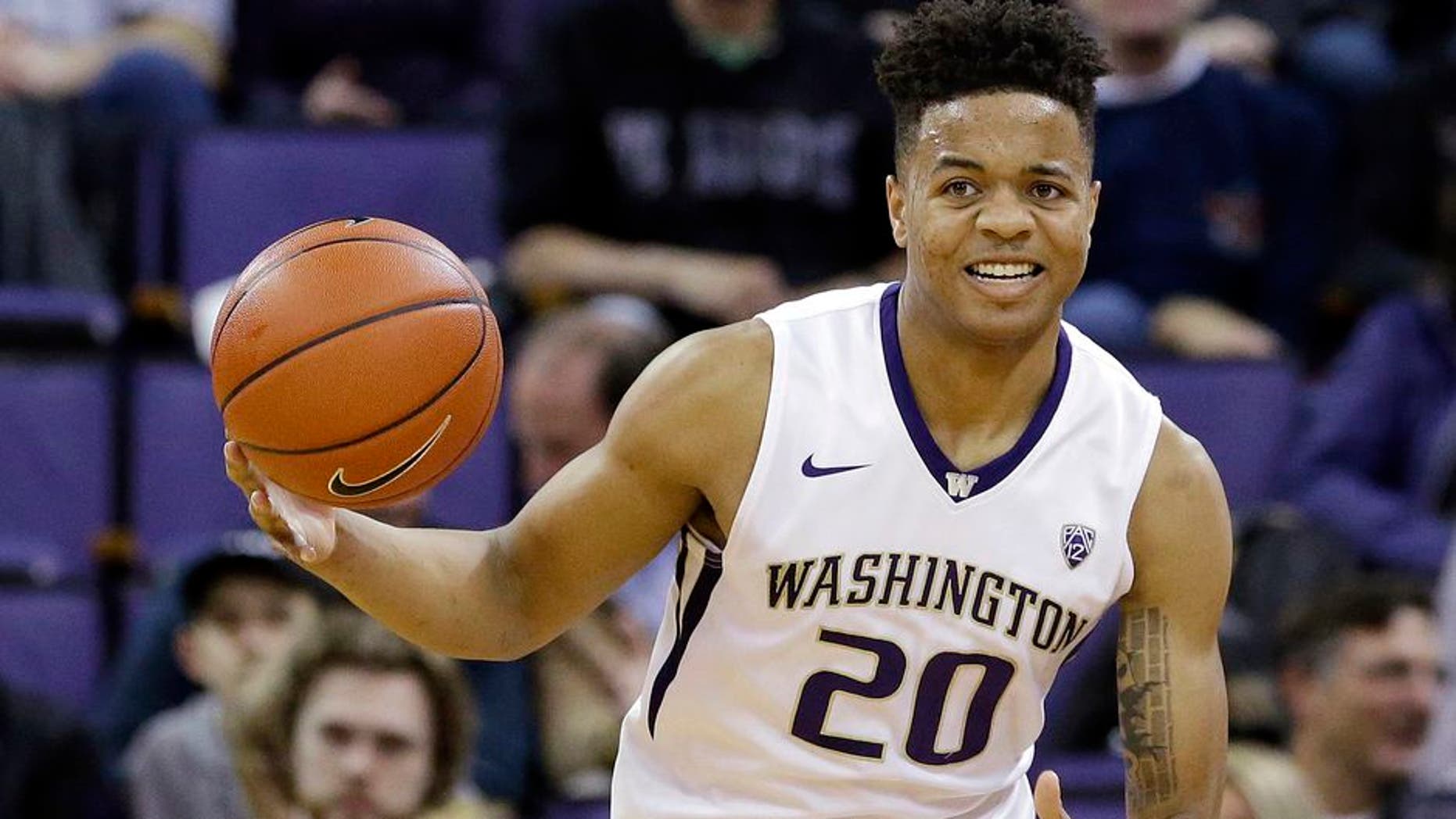 FILE - In this Feb. 18, 2017, file photo, Washington's Markelle Fultz brings the ball upcourt against Arizona during an NCAA college basketball game in Seattle. Fultz was selected to the AP All-Pac-12 Conference first team, Tuesday, March 7, 2017. (AP Photo/Elaine Thompson, File)