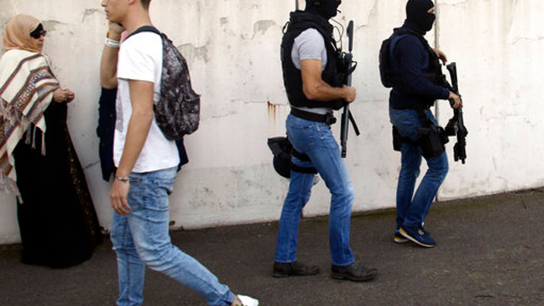 Members of law enforcement, right, patrolling the school after the attack.
