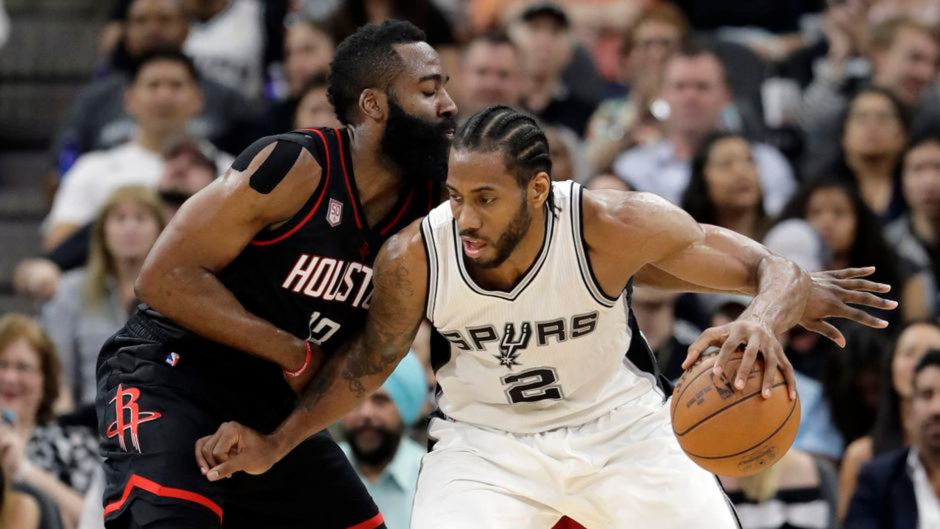 San Antonio Spurs forward Kawhi Leonard (2) works for an opportunity to the basket as Houston Rockets' James Harden, left, defends during the first half of Game 2 in a second-round NBA basketball playoff series, Wednesday, May 3, 2017, in San Antonio. (AP Photo/Eric Gay)