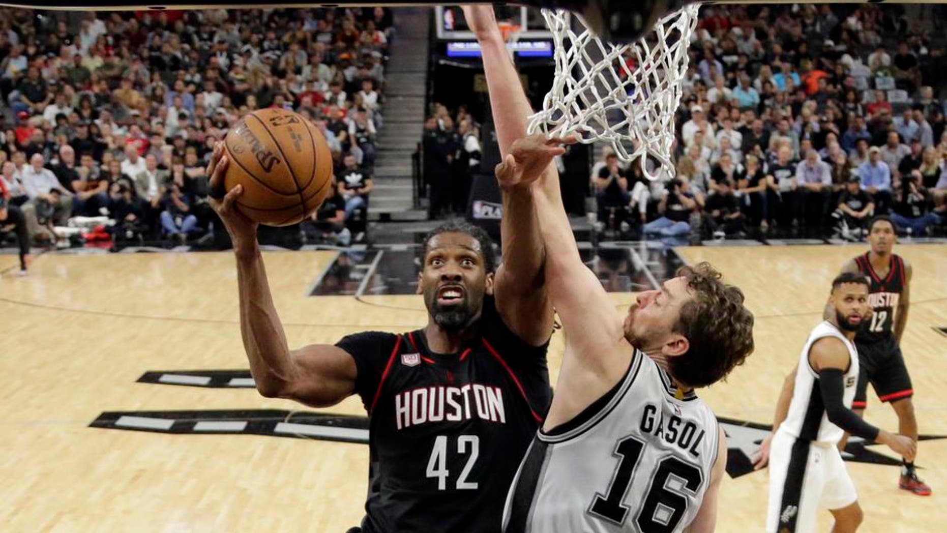 Houston Rockets center Nene Hilario (42) goes up for a shot as San Antonio Spurs' Pau Gasol (16) of Spain defends during the second half of Game 2 in a second-round NBA playoff series basketball game, Wednesday, May 3, 2017, in San Antonio. (AP Photo/Eric Gay)