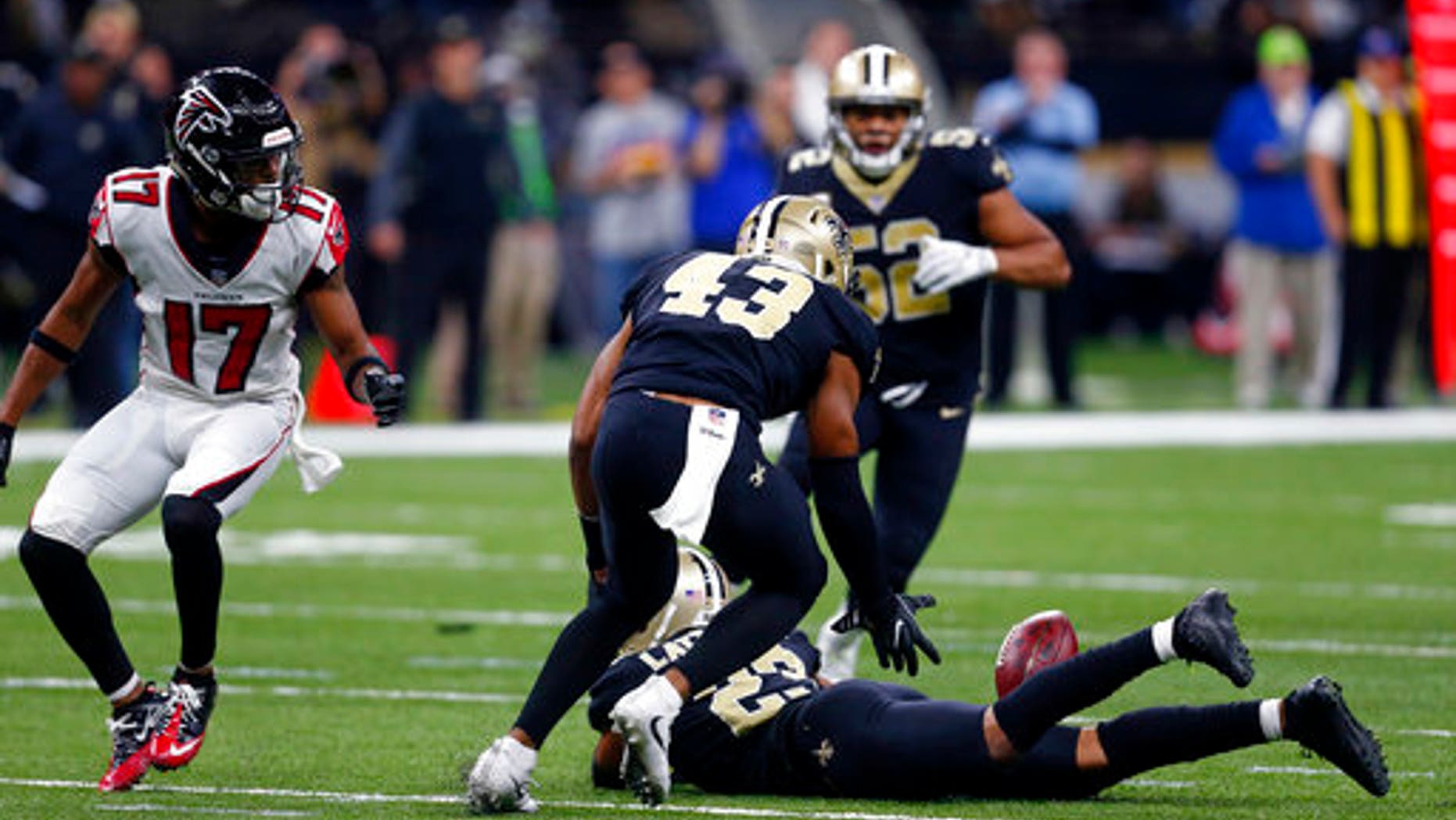 New Orleans Saints free safety Marcus Williams (43) scoops up an interception as the ball lands on the back of cornerback Marshon Lattimore.