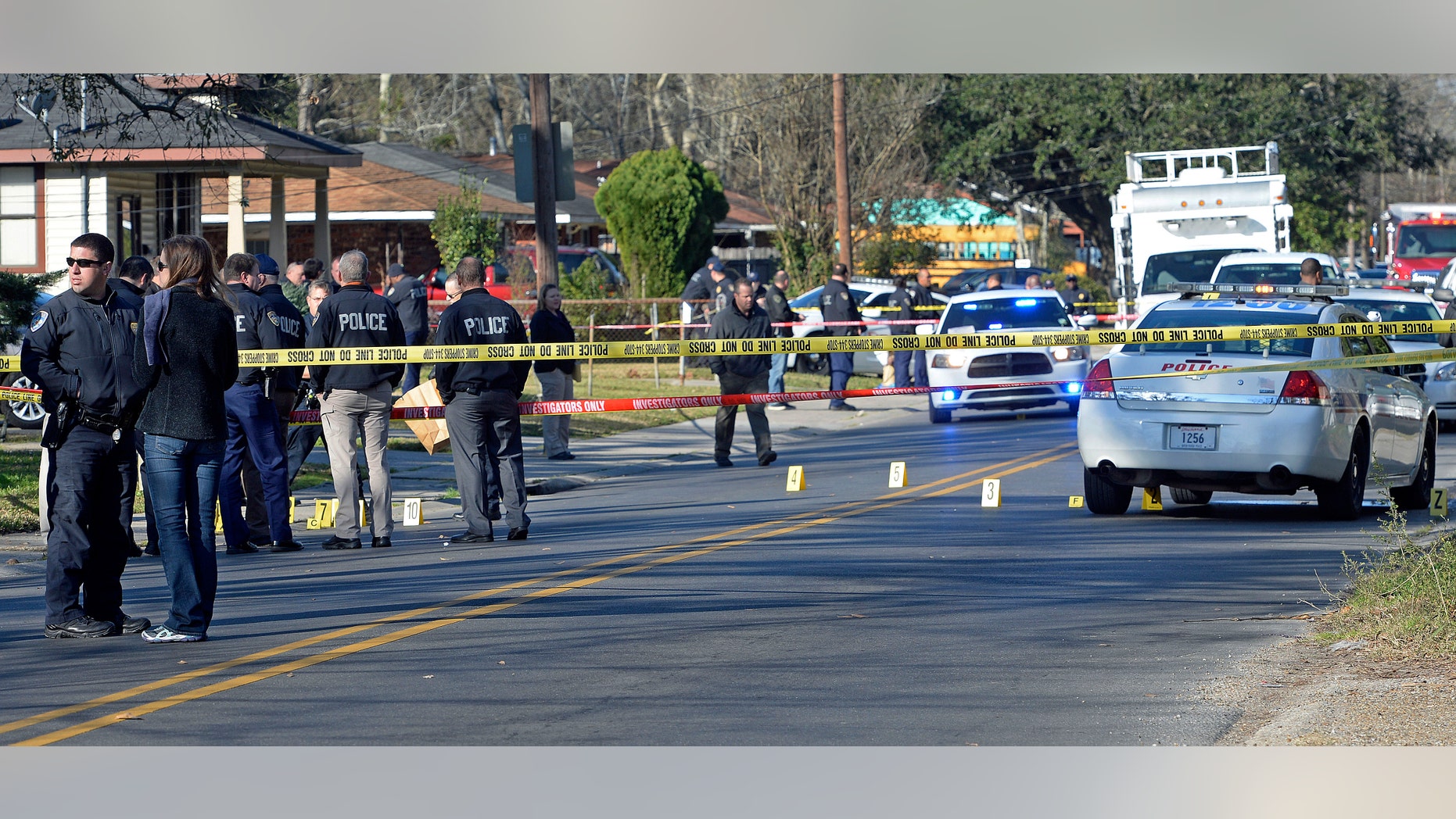 Officers investigating the shooting scene on Saturday.