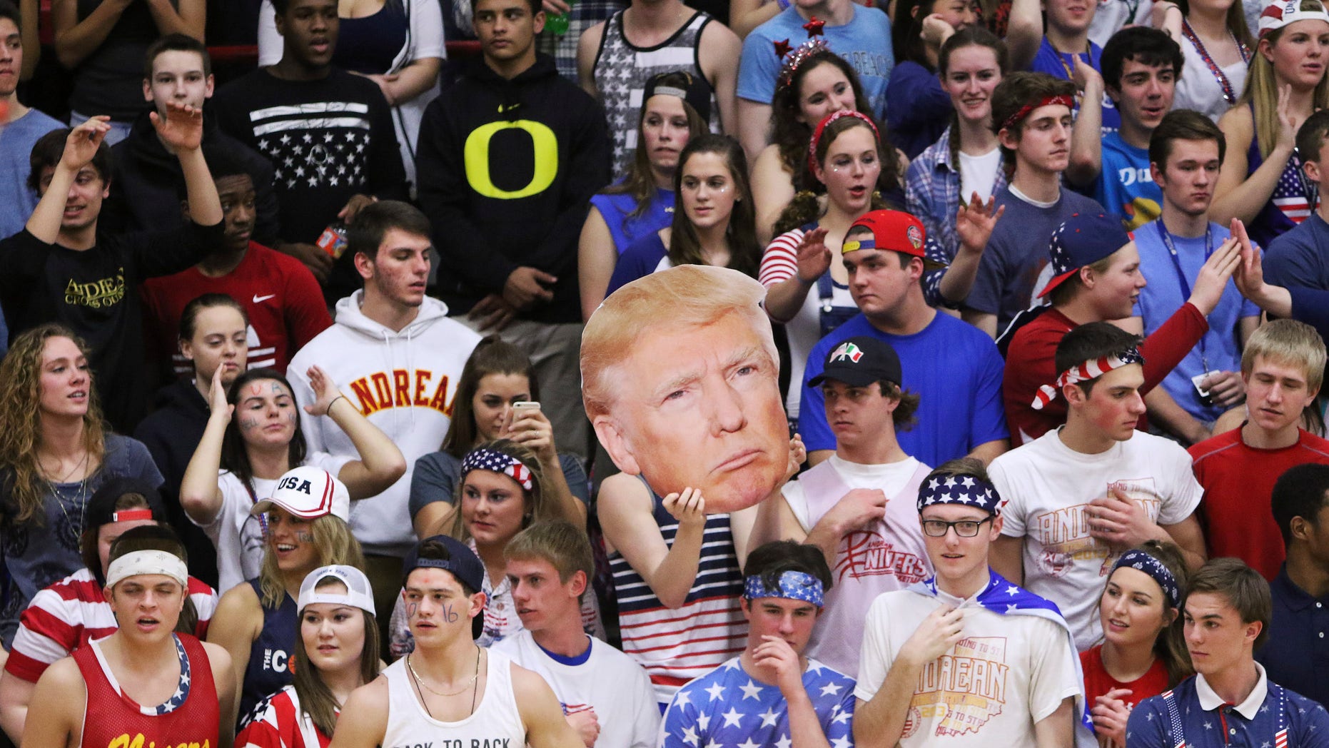 The Andrean High School student section holds up a picture of GOP presidential candidate Donald Trump during their school's basketball game against Bishop Noll Institute Friday.