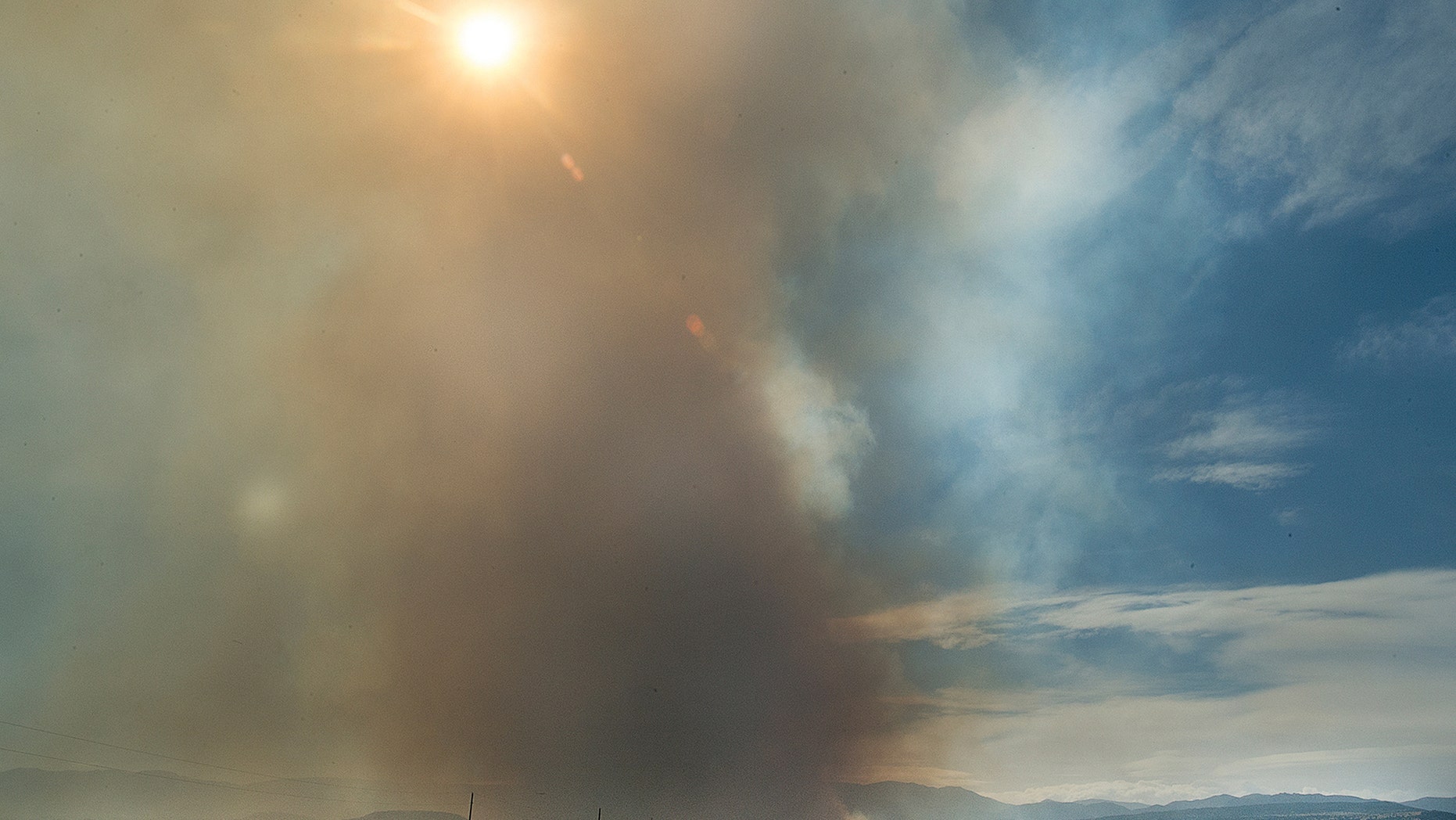 Smoke billows into the sky near Beulah, Colo., during a wildfire that began in the early afternoon on Monday.