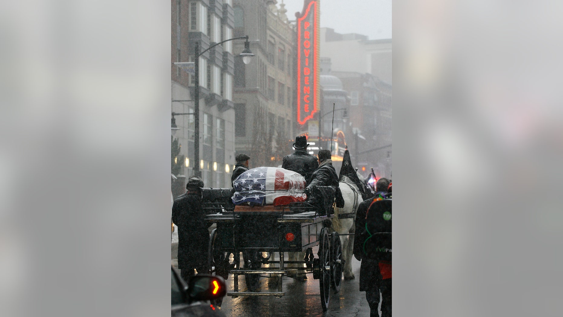 The casket of former Providence Mayor Buddy Cianci passes the Providence Performing Arts Center on a horse drawn carriage on its way to the Cathedral of Saints Peter and Paul, Monday, Feb. 8, 2016, in Providence, R.I. Cianci died Jan. 28 at age 74. He was the city's longest-serving mayor. (AP Photo/Stew Milne)
