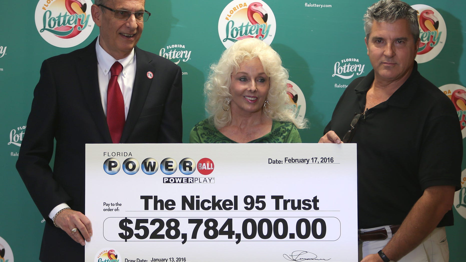 Florida Lottery Secretary Tom Delacenserie (left) with winners Maureen Smith and David Kaltschmidt.