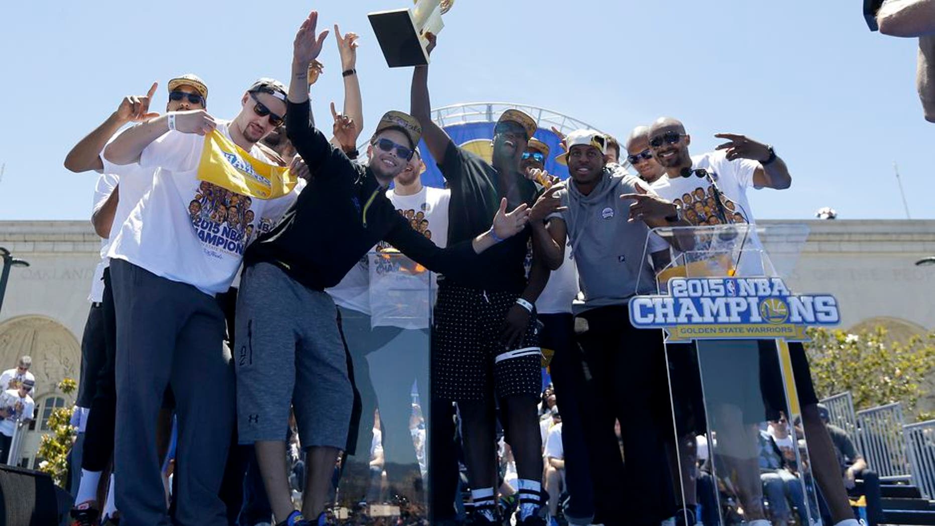 Golden State Warriors players celebrate after a parade and rally for winning the NBA championship in Oakland, Calif., Friday, June 19, 2015. (AP Photo/Jeff Chiu)