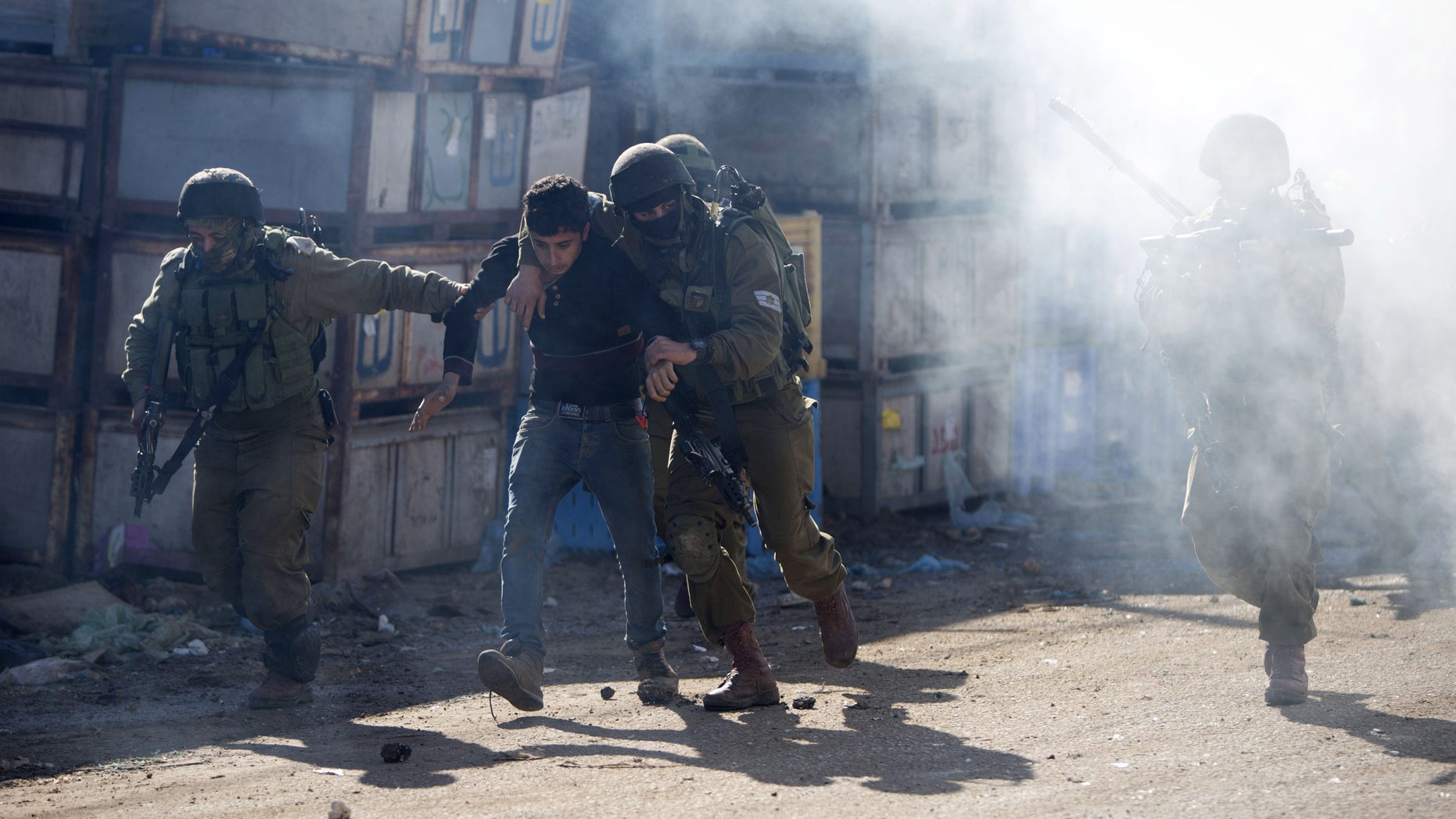 Israeli soldiers arrest a Palestinian protester during clashes in the West Bank village of Kabatiya Thursday.