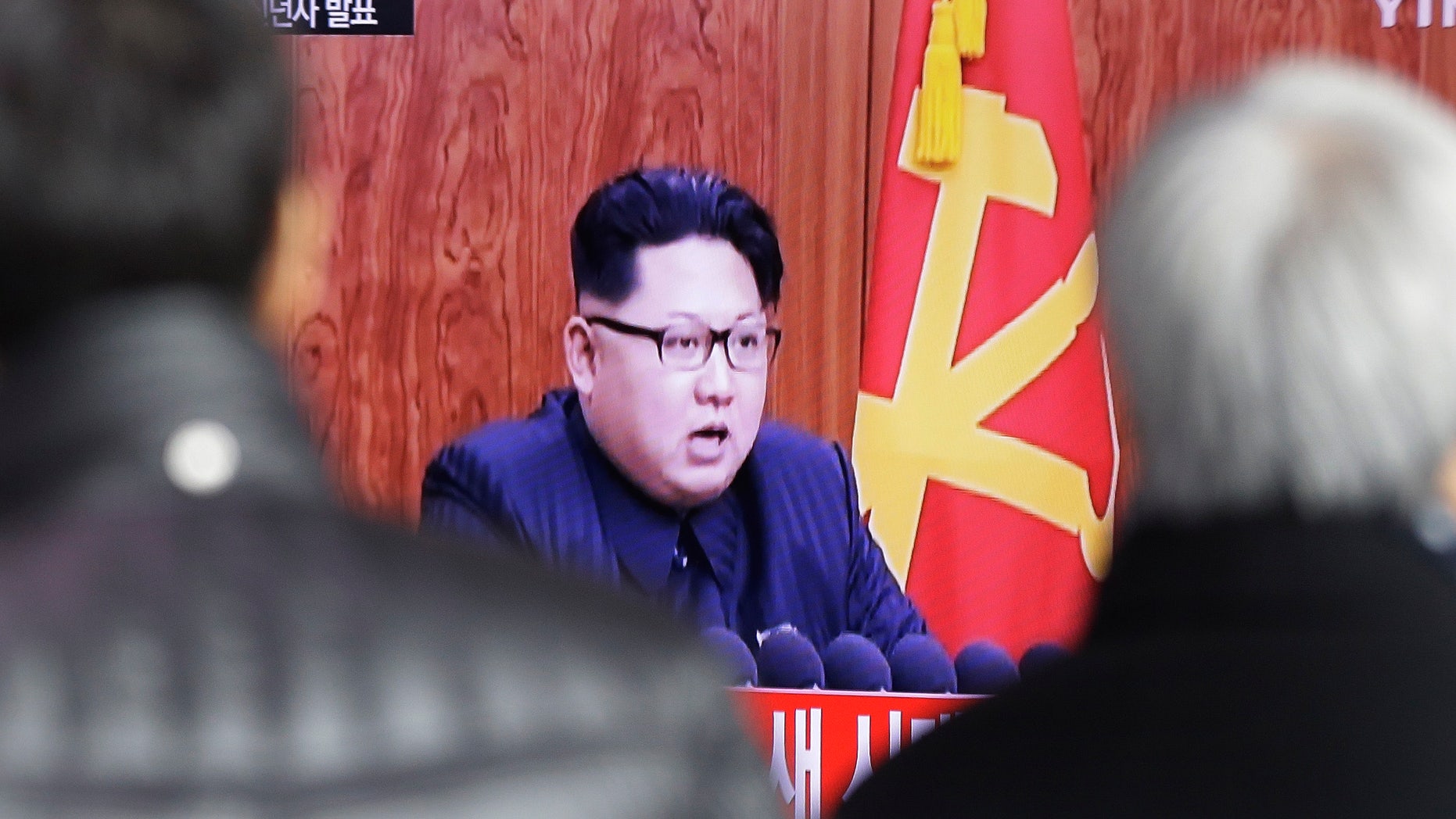 South Koreans watch a TV news program showing North Korean leader Kim Jong Un's New Year speech, in Seoul.