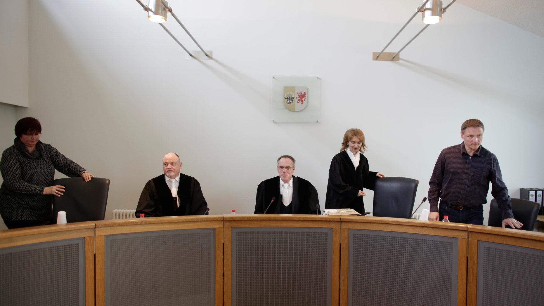 Klaus Kabisch, center, presiding judge at the trial against former SS medic Hubert Zafke arrives with the panel of judges.