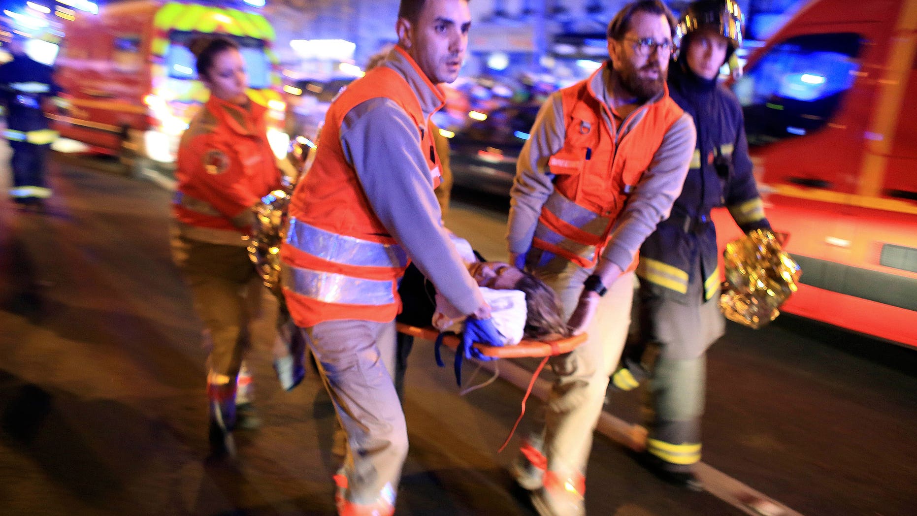 In this Nov. 13, 2015 file photo, a woman is evacuated from the Bataclan concert hall after a shooting in Paris. (AP Photo/Thibault Camus, File)