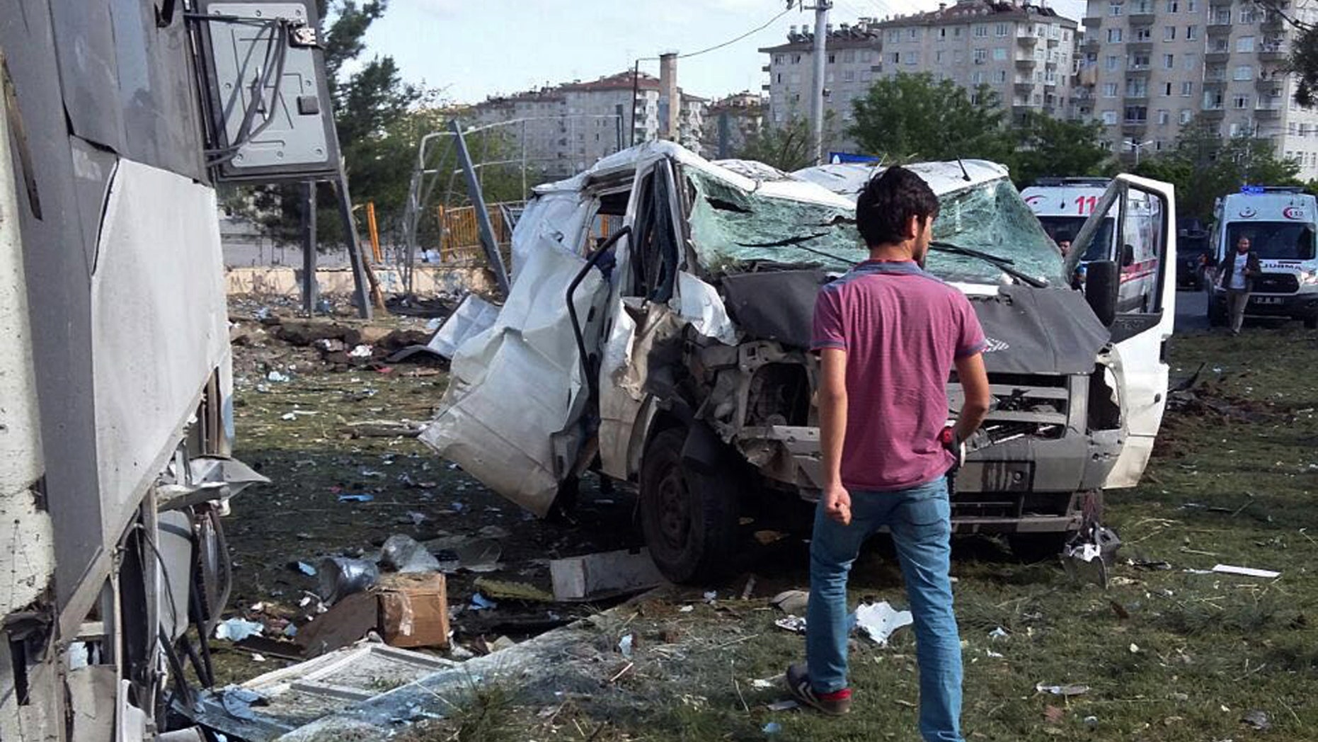 ALTERNATIVE CROP OF ANK102 - A security officer works at the explosion site after a car bomb struck a bus carrying Turkish police officers in the mainly-Kurdish city of Diyarbakir, Turkey, Tuesday, May 10, 2016, wounding at least 12 people, the state-run news agency reported. The Anadolu Agency said the attack in Diyarbakir's troubled Baglar neighborhood was carried out by the outlawed Kurdistan Workers' Party, or PKK, as the bus was passing by. (AP Photo)