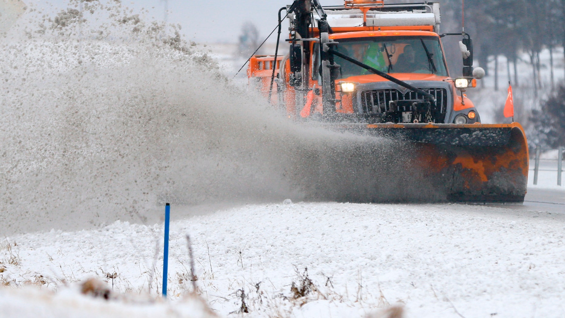 A snowplow clears snow off of Interstate 80 near Earlham, Iowa, Tuesday, Feb. 2, 2016. A winter storm that dumped heavy snow on Denver and much of Colorado has moved east into Nebraska and Iowa. (AP Photo/Nati Harnik)