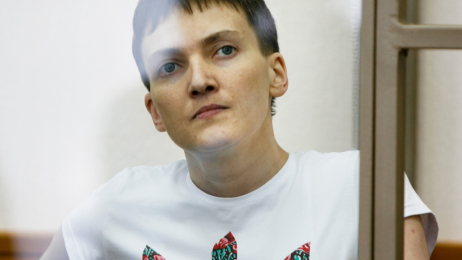 Nadezhda Savchenko sits in a glass cage during her trial.