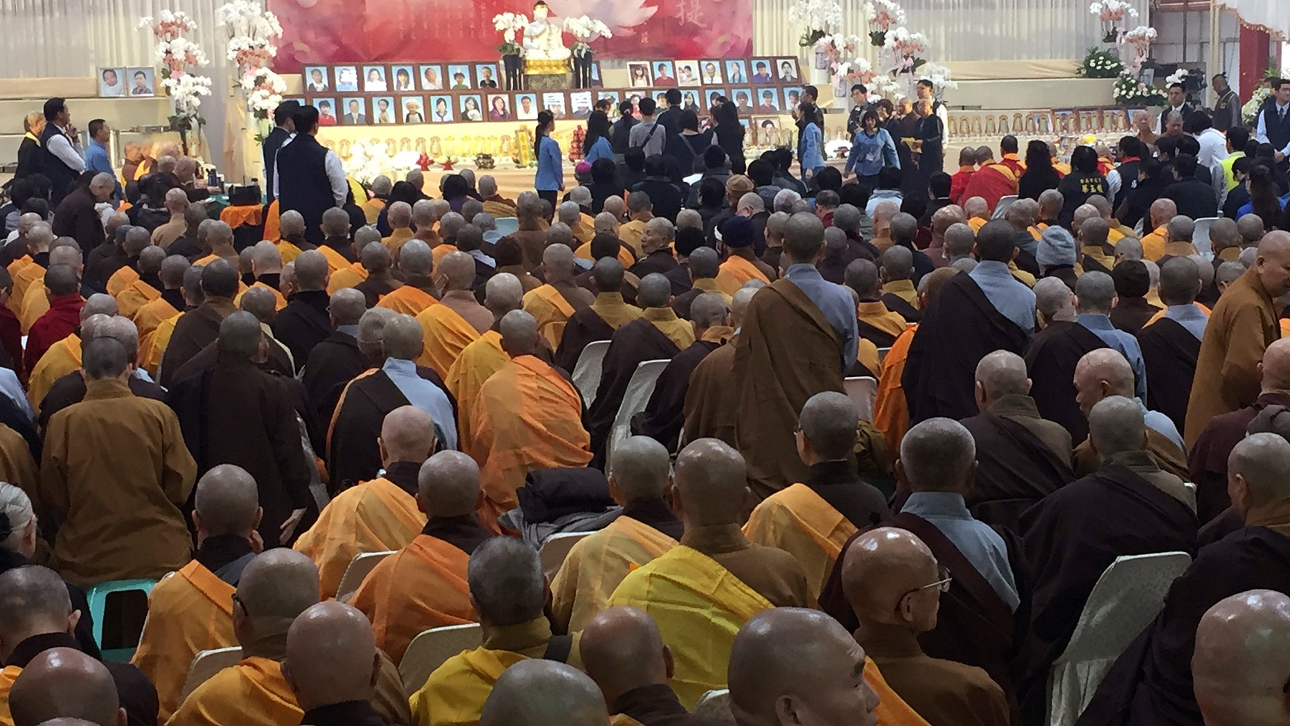 Relatives, religious leaders and government officials at Friday's memorial in Tainan.