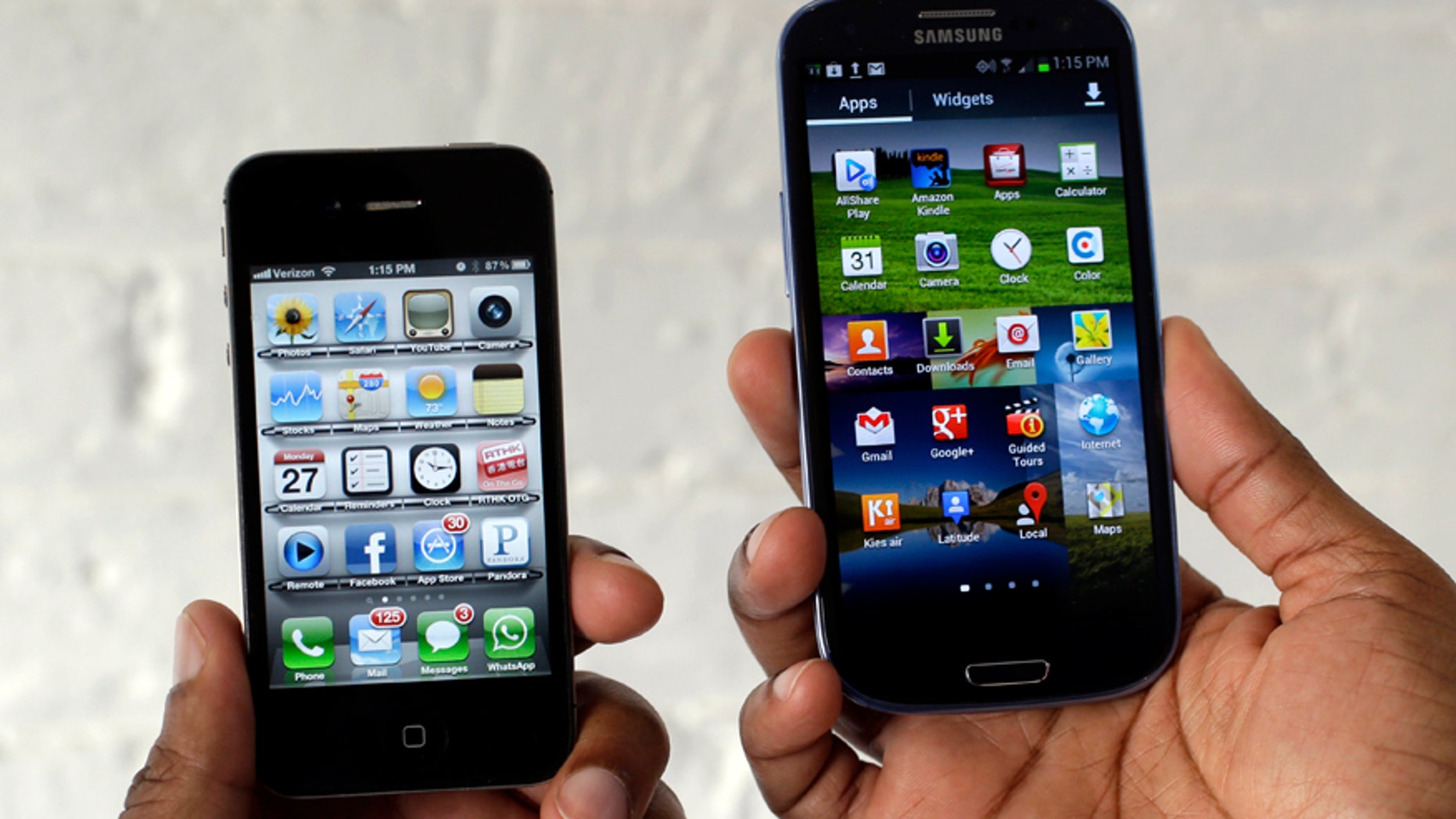 In this Aug. 27, 2012 photo, the Apple iPhone 4s, left, is displayed next to the Samsung Galaxy S III at a store in San Francisco.