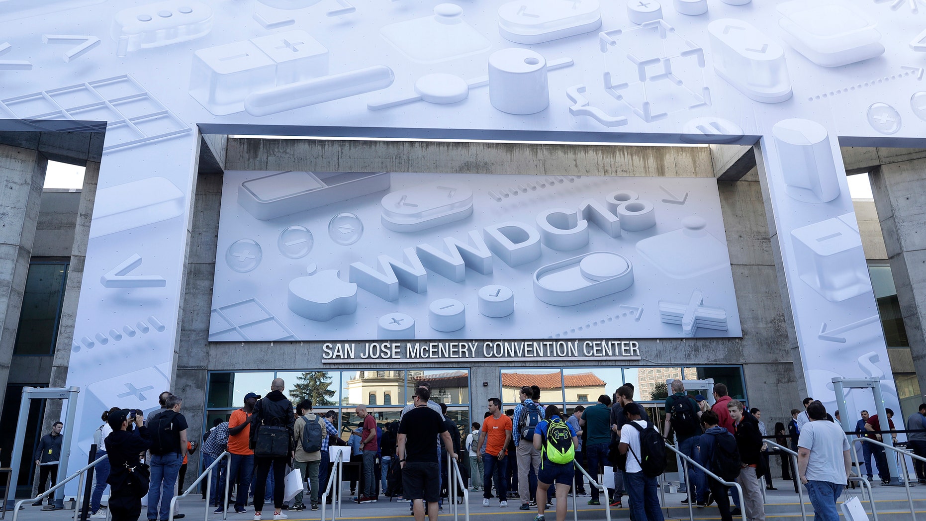 Attendees line up outside of the McEnery Convention Center for the Apple Worldwide Developers Conference in San Jose, Calif., Monday, June 4, 2018. (AP Photo/Marcio Jose Sanchez)