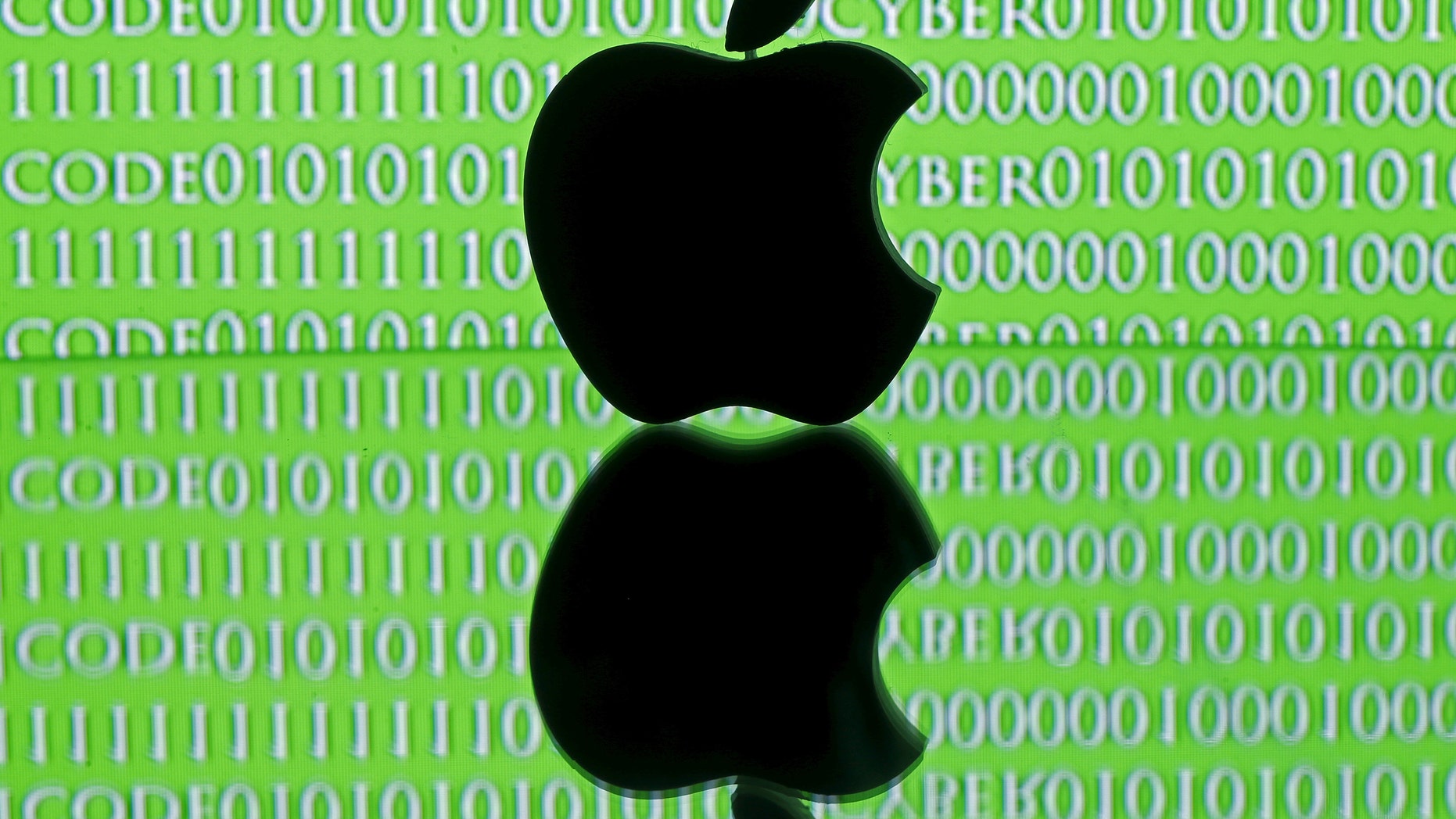 A 3D printed Apple logo is seen in front of a displayed cyber code in this illustration taken Feb. 26, 2016. (REUTERS/Dado Ruvic/Illustration)