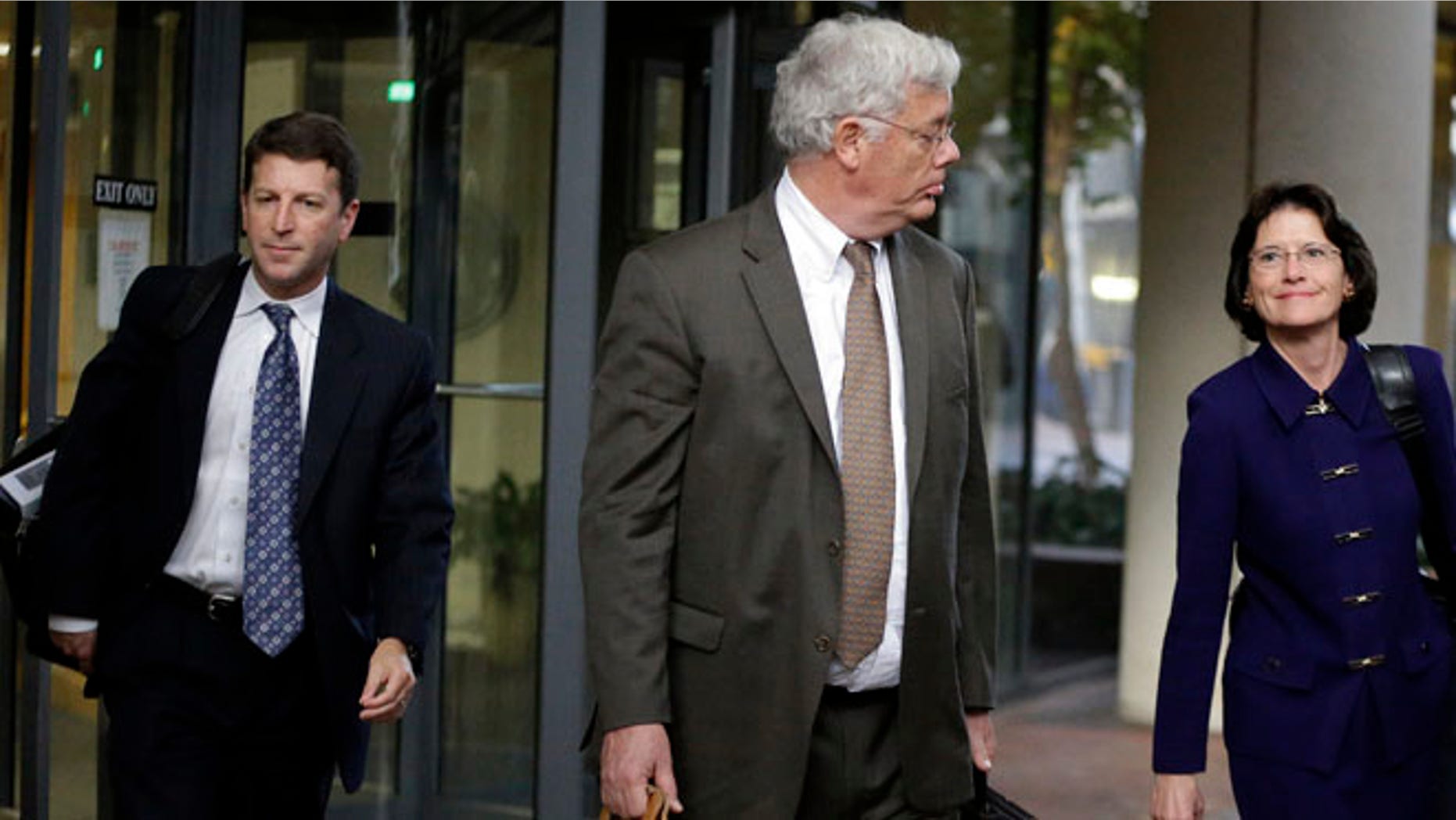 Nov. 13, 2013: Harold McIlhenny, center, an attorney representing Apple Computer in the Apple Samsung trial, exits a federal courthouse in San Jose, Calif.