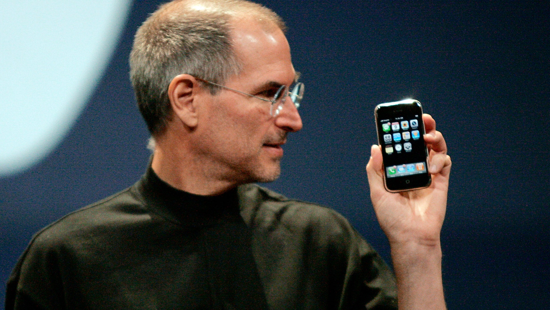 File photo - Apple CEO Steve Jobs holds the first iPhone in San Francisco, Calif. Jan. 9, 2007. (REUTERS/Kimberly White)