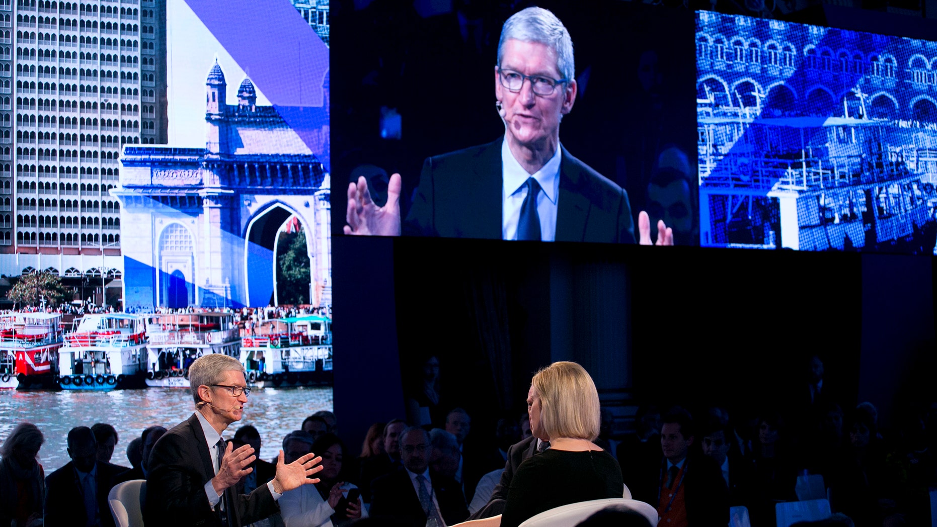 Apple CEO Tim Cook, lower left, speaks at the Bloomberg Global Business Forum, Wednesday, Sept. 20, 2017, in New York. (AP Photo/Mark Lennihan)