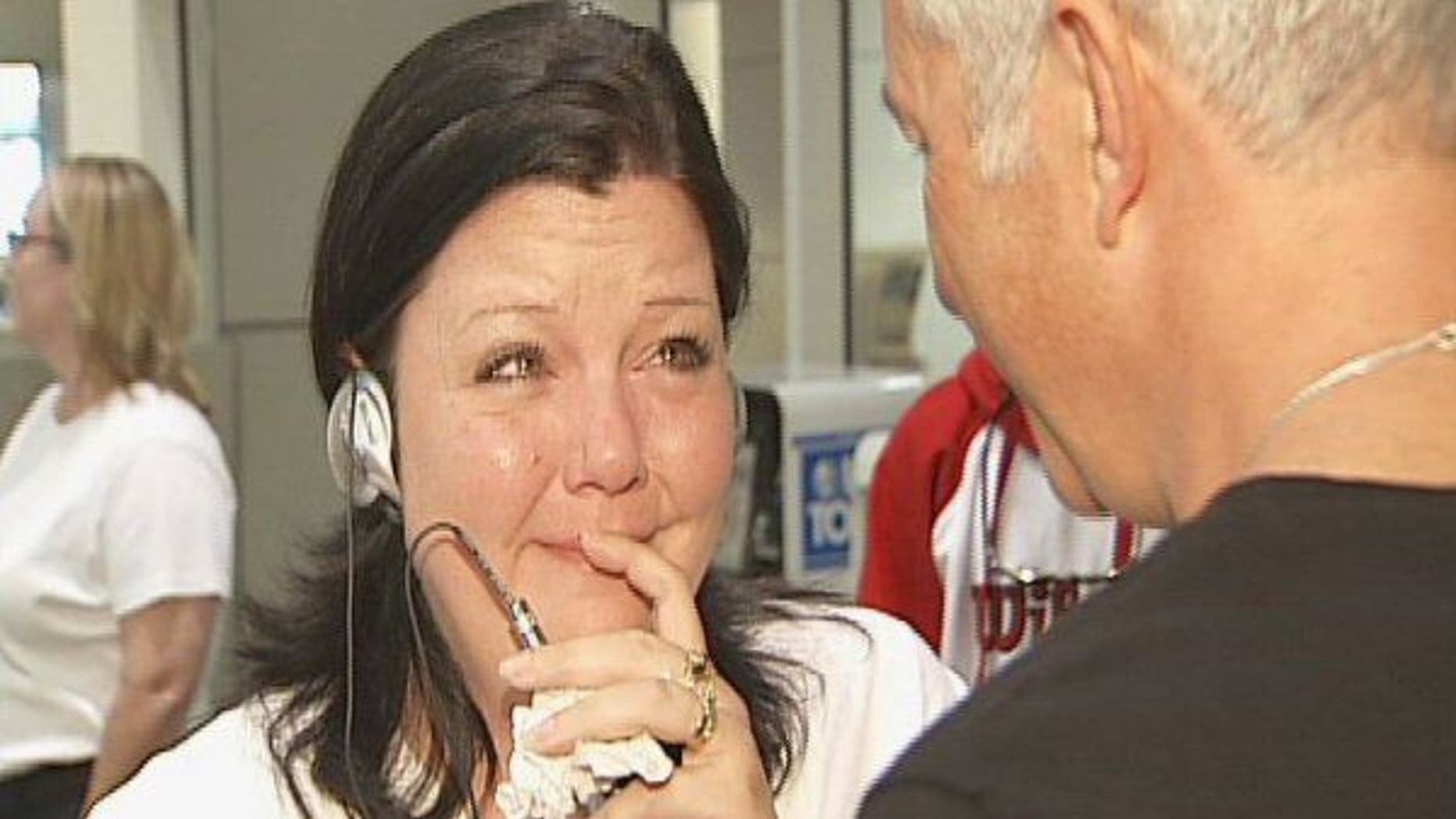 April Beaver listens to her deceased son Caleb's heart, beating in donor recipient Chuck Shelton's chest, through a stethoscope.
