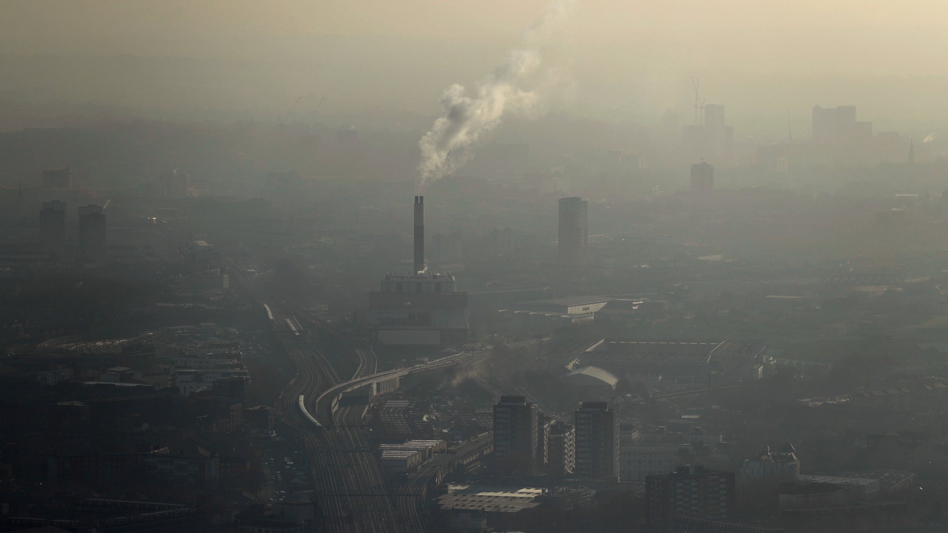 Pollution is seen over south east London through a window in a viewing area of the 95-storey skyscraper The Shard, the tallest building in Britain at 309.6 metres, in London, Thursday, Jan. 19, 2017. Eight London boroughs issued high pollution warnings Thursday. (AP Photo/Matt Dunham)