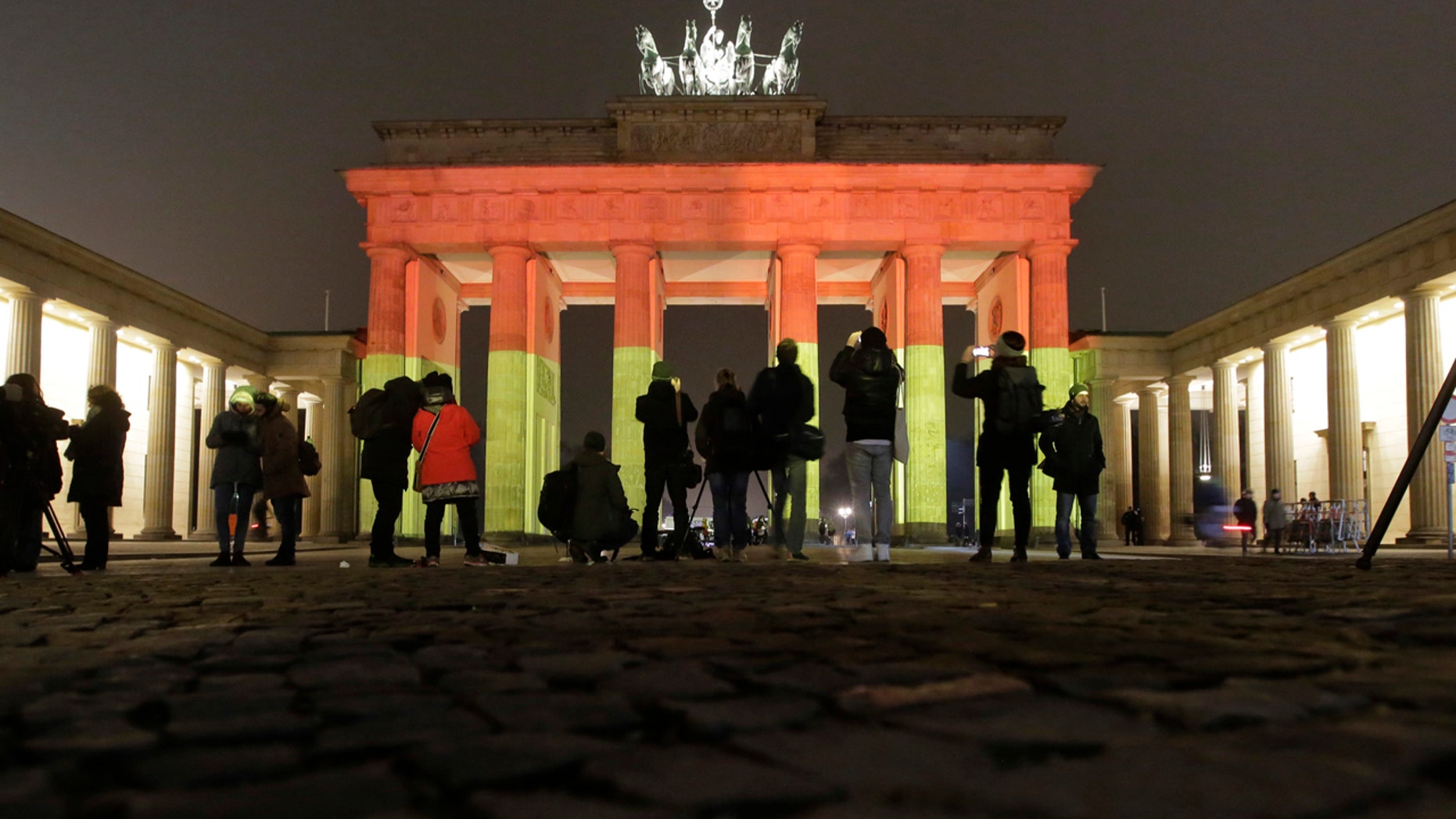 The Brandenburg Gate is illuminated in the colors of the German flag in Berlin, Germany, Tuesday, Dec. 20, 2016, the day after a truck ran into a crowded Christmas market and killed several people. (AP Photo/Markus Schreiber)