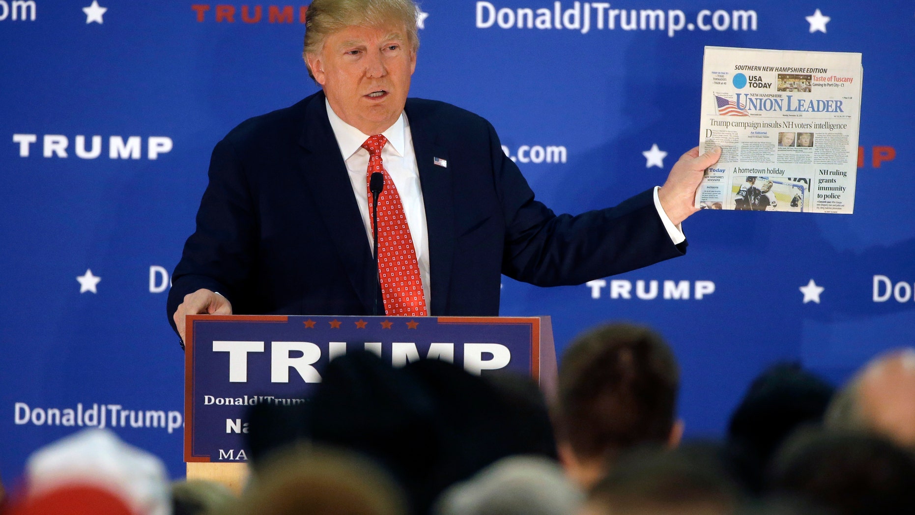Dec. 28, 2015: Republican presidential candidate Donald Trump displays a copy of the Union Leader newspaper while addressing an audience during a campaign event.