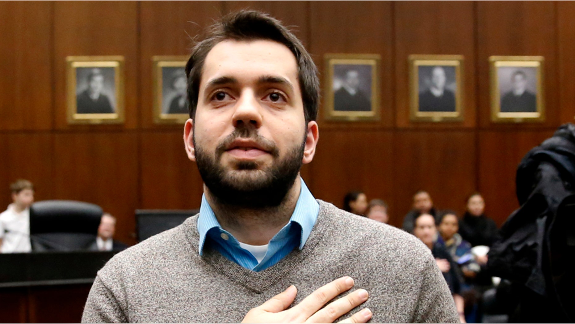 Rohi Atassi, right, from Syria, leads new US citizens in the Pledge of Allegiance after Atassi and 116 others from 37 countries took the oath of citizenship during a naturalization ceremony Tuesday, Feb. 7, 2017, in Chicago. Atassi has not returned to Syria since his last visit in the fall of 2011. (AP Photo/Charles Rex Arbogast)