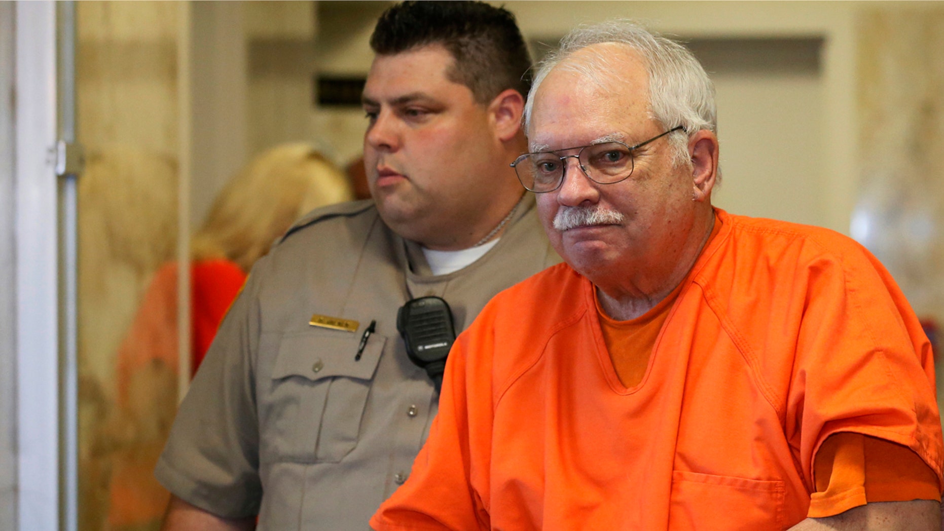 May 31, 2016: Robert Bates, a former Oklahoma volunteer sheriff's deputy who said he mistook his handgun for his stun gun when he fatally shot an unarmed suspect in 2015, is escorted from the courtroom following his sentencing at the courthouse in Tulsa.