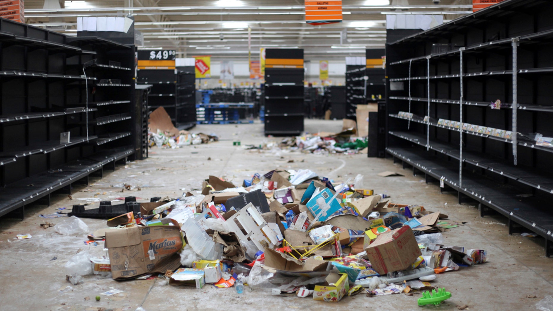 Supermarket displays stand empty and looted following protests caused by a 20 percent hike in gasoline prices, in Veracruz, Mexico, Saturday, Jan. 7, 2017.