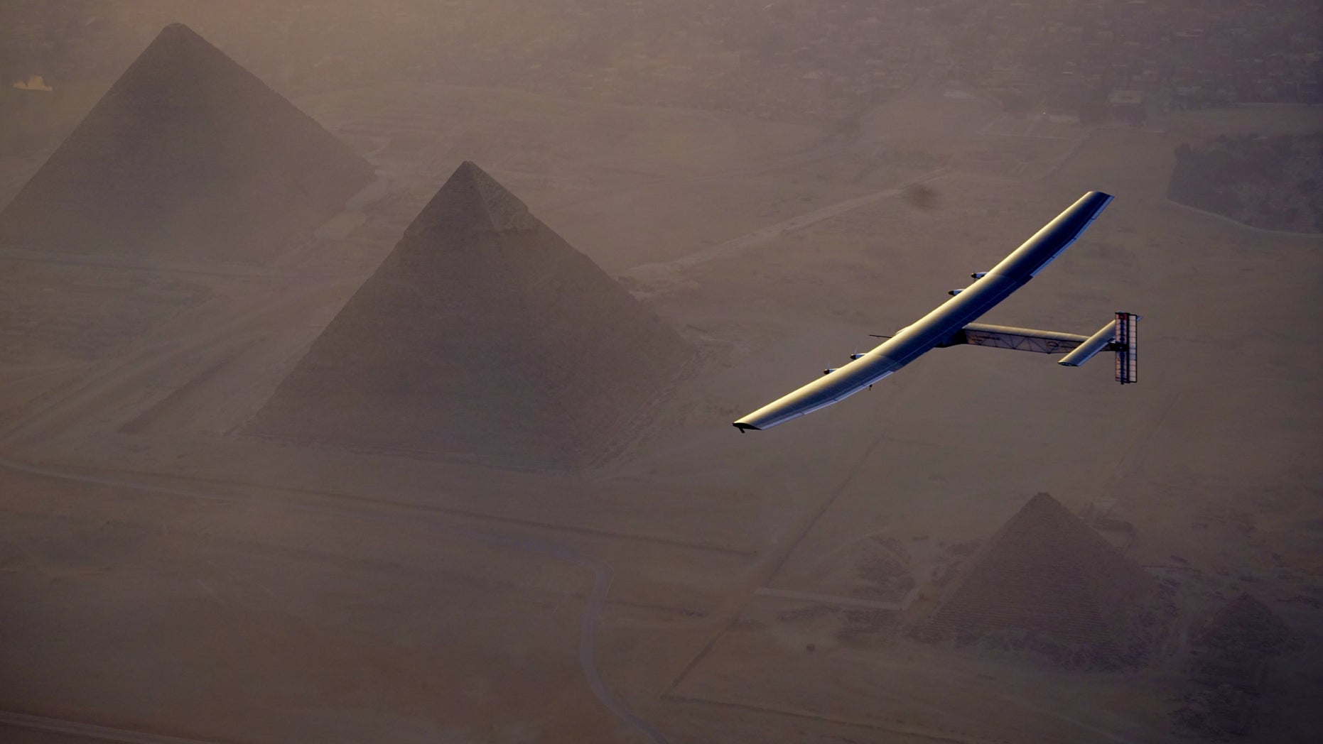 In this Wednesday, July 13, 2016, handout image provided by Solar Impulse, the Solar Impulse 2 flying over the pyramids, Egypt Cairo. The experimental solar-powered airplane has arrived in Egypt as part of its global voyage.