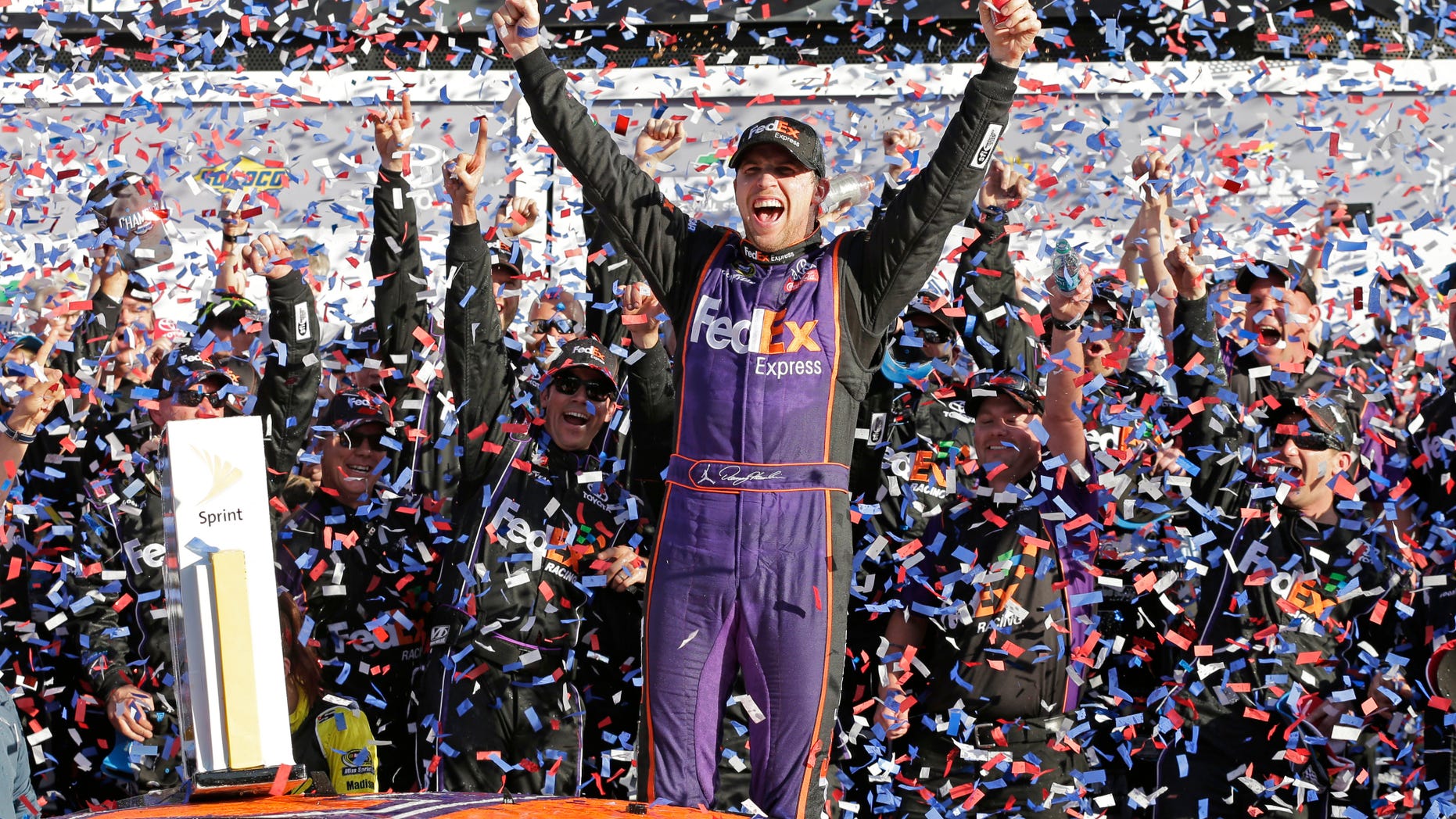 Denny Hamlin celebrates in Victory Lane after winning the NASCAR Daytona 500 Sprint Cup Series auto race.