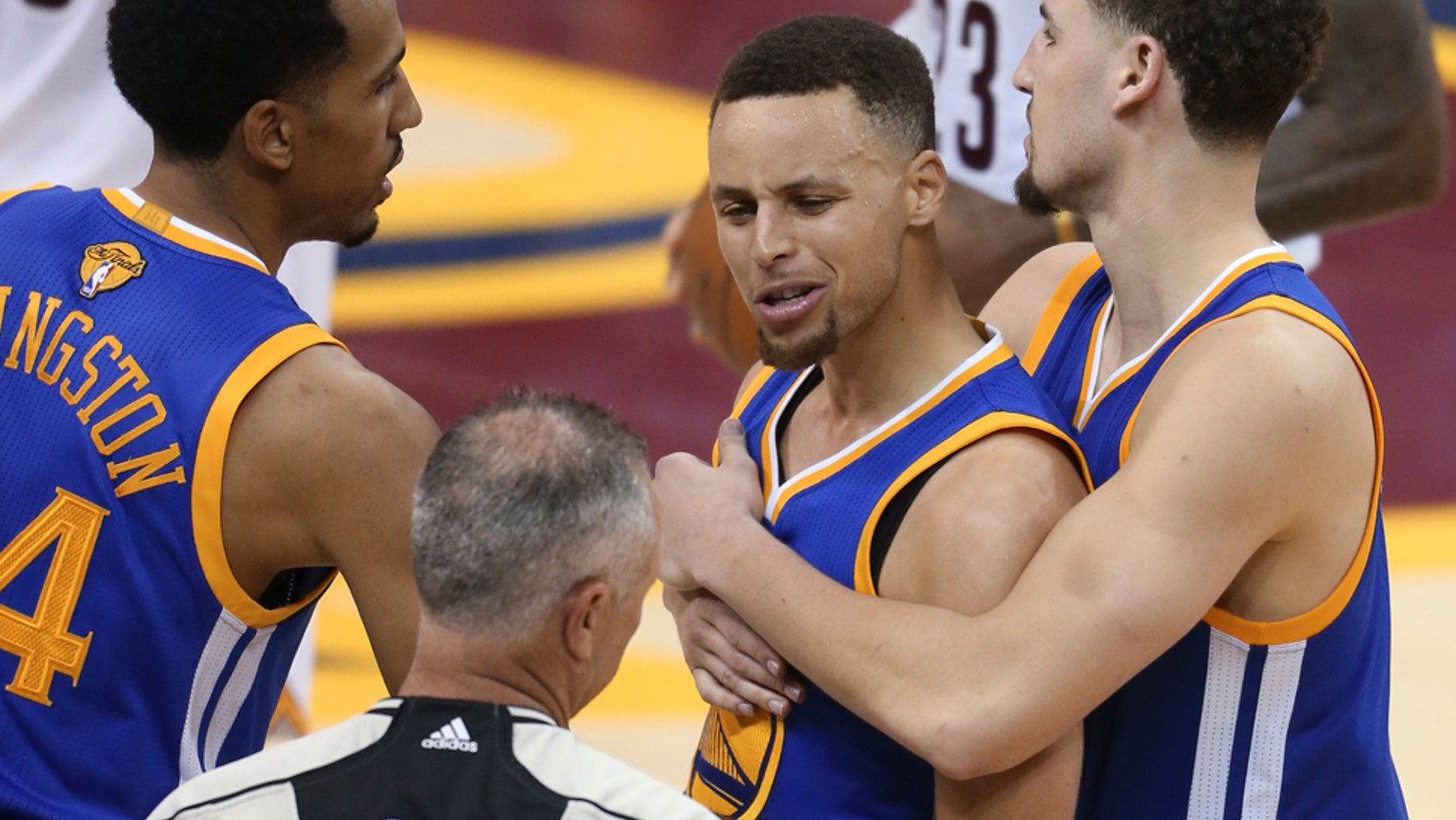 June 16, 2016: Golden State Warriors guard Stephen Curry is held back from referee Jason Phillips by Shaun Livingston, left, and Klay Thompson, right, while reacting to being called for his sixth foul during Game 6 of the NBA Finals