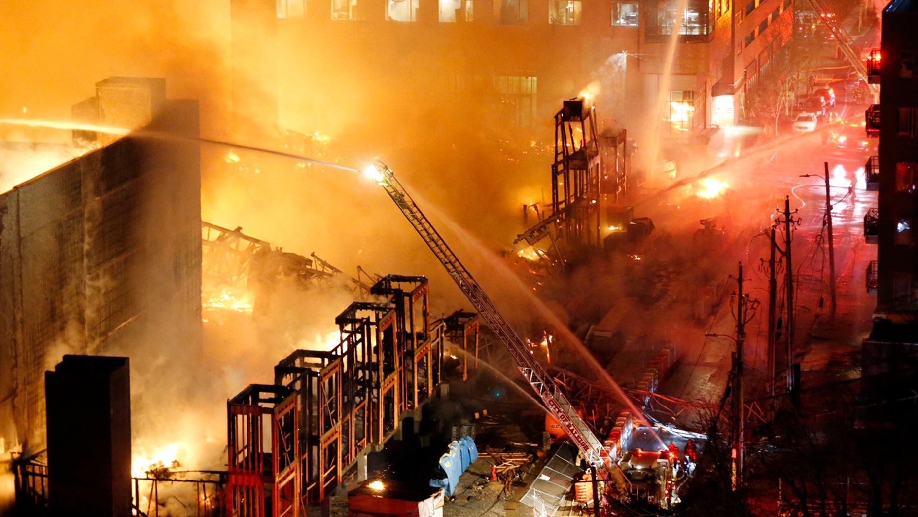 A large fire engulfed a building under construction in downtown Raleigh, N.C. Thursday night, March 16, 2017. A statement from the Raleigh Police Department says preliminary information indicates there were no injuries.