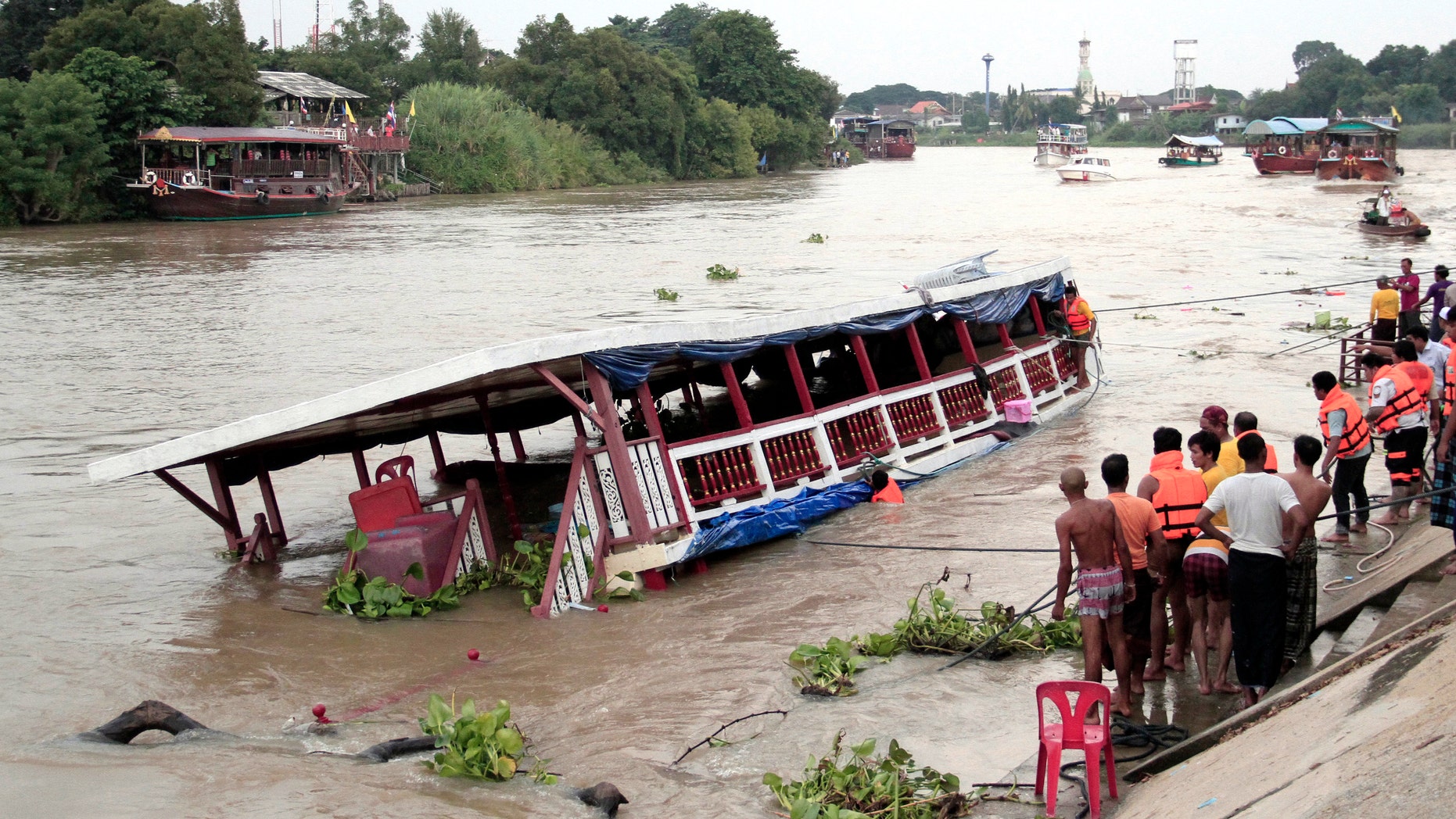 Thai rescue teams search for victims after a boat capsized in Thailand on Sunday.