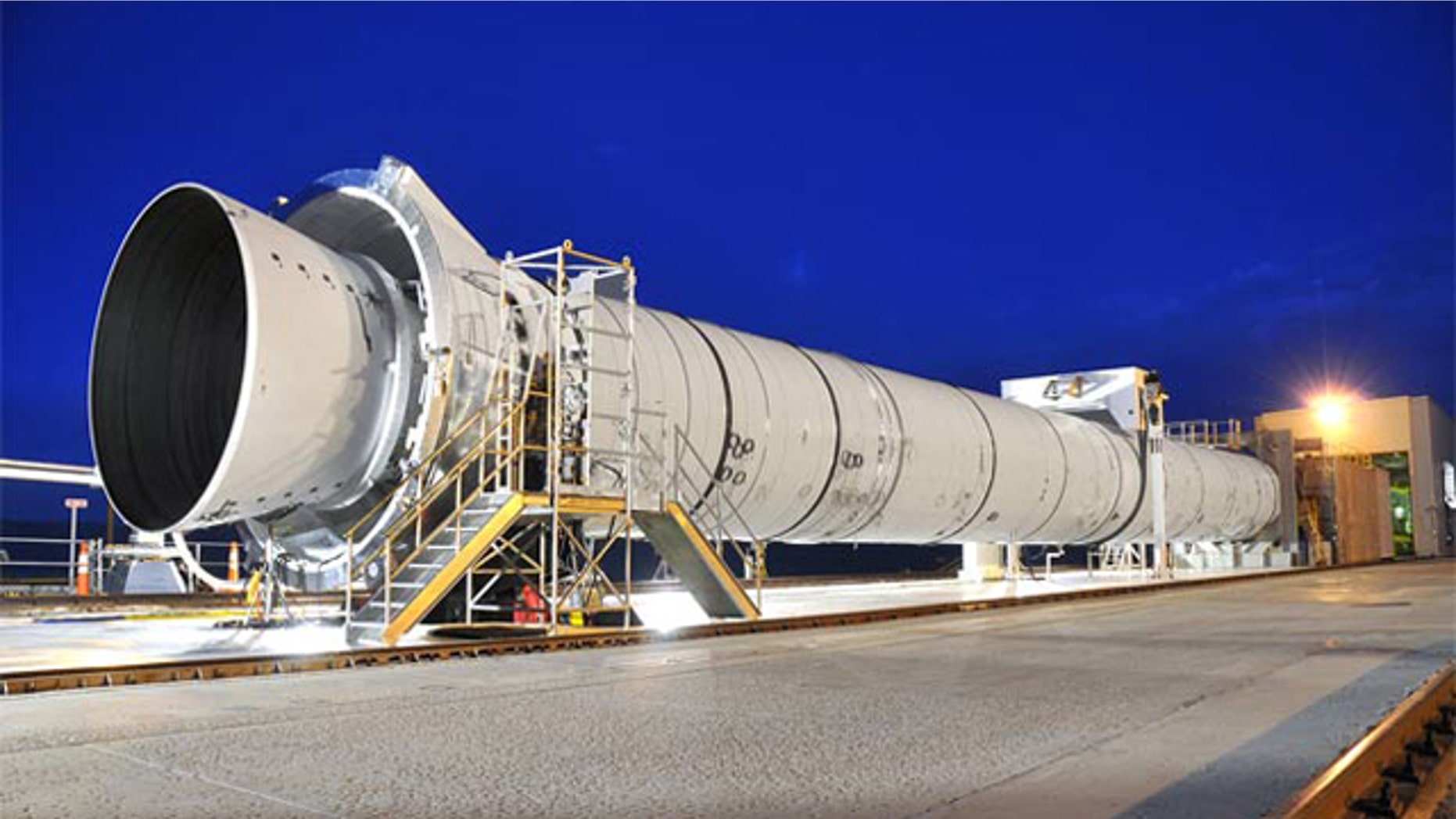 NASA's next-generation, five-segment solid rocket development motor -- or DM-2 -- is fully assembled in its test stand at ATK in Promontory, Utah. Tuesday morning, engineers plan to conduct a static-fire test -- firing the rocket horizontally while it's bolted to the ground.