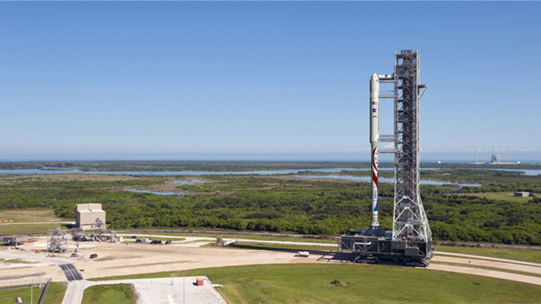 The new Liberty launch vehicle, which draws on parts of NASA's cancelled Ares I rocket and Europe's Arian 5 rocket, will use existing infrastructure at Kennedy Space Center, such as the Mobile Launcher shown here in this illustration. The rocket proposal was developed by ATK and Astrium.